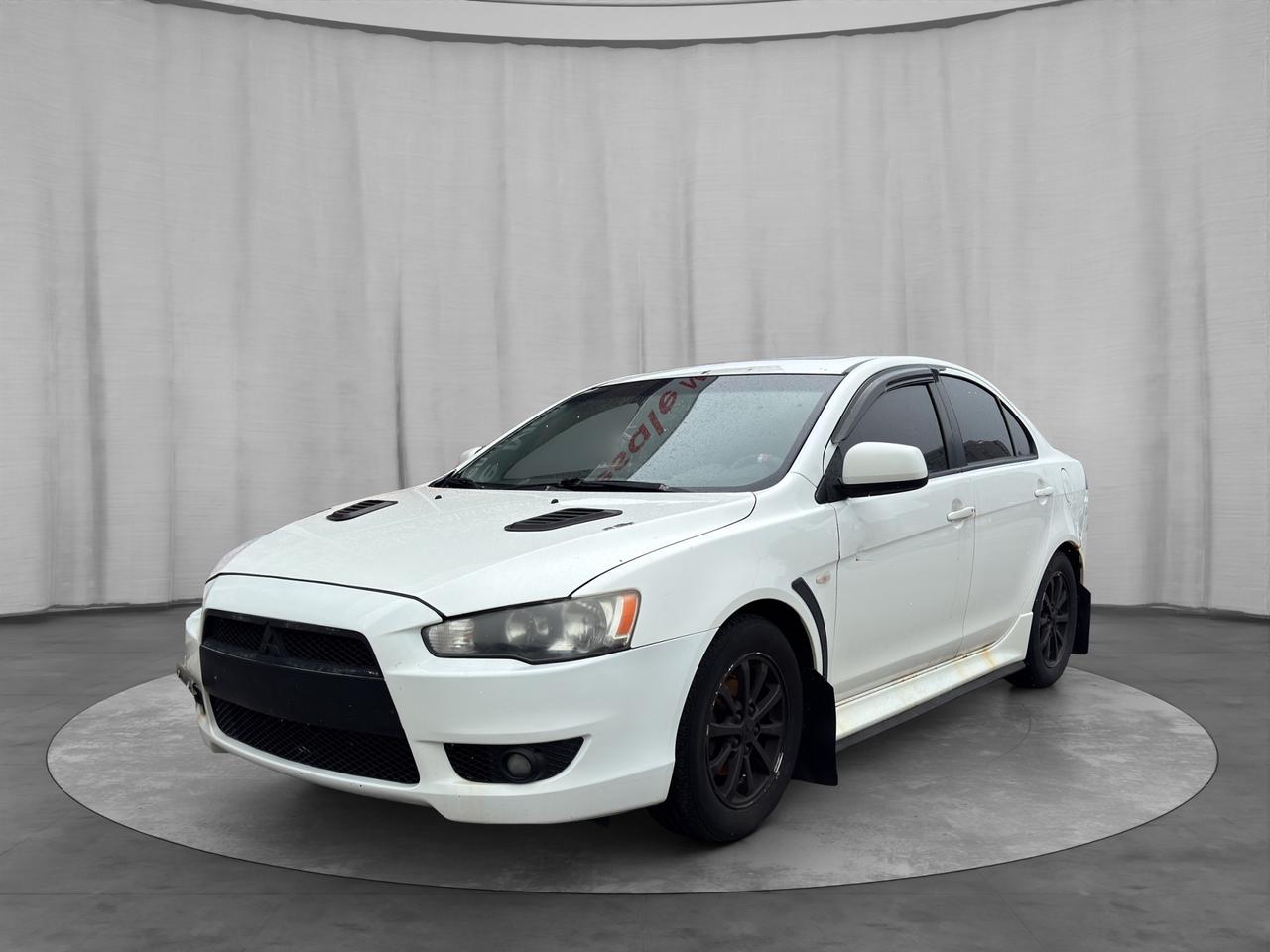 <h2><span> <strong>2011 Mitsubishi Lancer SE  Sport Sedan | Heated Seats | Fuel Efficient</strong></span></h2><p>The 2011 Mitsubishi Lancer SE offers sporty styling, reliable performance, and everyday practicality. With its comfortable interior and efficient engine, this Lancer is a great option for commuting or as an affordable daily driver.</p><hr><h3><span> <strong>Performance & Efficiency</strong></span></h3><ul><li>2.0L 4-Cylinder Engine</li><li>Automatic Transmission</li><li>Front-Wheel Drive</li><li>Excellent fuel economy</li><li>Smooth and reliable driving experience</li></ul><hr><h3><span> <strong>Interior & Comfort</strong></span></h3><ul><li>Premium cloth seating</li><li><strong>Heated front seats</strong></li><li>Air conditioning</li><li>Keyless entry</li><li>Spacious and practical cabin</li><li>Split-folding rear seats</li></ul><hr><h3><span> <strong>Technology & Features</strong></span></h3><ul><li>Bluetooth hands-free calling & audio</li><li>AM/FM audio system</li><li>Steering wheel-mounted controls</li><li>USB / AUX connectivity</li></ul><hr><h3><span> <strong>Safety & Driver Assistance</strong></span></h3><ul><li>Traction Control</li><li>Stability Control</li><li>Anti-lock Braking System (ABS)</li><li>Multiple airbags</li><li>Tire Pressure Monitoring System</li></ul><hr><h3><span> <strong>Exterior Highlights</strong></span></h3><ul><li>Sporty Lancer styling</li><li>Alloy wheels</li><li>Clean and aggressive design</li><li>Compact and easy to drive</li></ul><hr><h3><span> <strong>Kings Auto Service Package</strong></span></h3><p> Safety Inspection Completed<br> Carfax Report Available<br> Professional Interior & Exterior Detail<br> Financing & Trade-In Options Available</p><hr><h3><span> <strong>Pricing & Disclosure</strong></span></h3><p>Standard $549 safety certification & licensing fee applies. Price does not include HST.</p><span id=jodit-selection_marker_1777432866490_7117768767916408 data-jodit-selection_marker=start style=line-height: 0; display: none;></span><hr style=font-family: open-sans, -apple-system, BlinkMacSystemFont, "Segoe UI", Roboto, Oxygen, Ubuntu, Cantarell, "Fira Sans", "Droid Sans", "Helvetica Neue", sans-serif;><h3><span> <strong>Available Now at Kings Auto Ltd</strong></span></h3>