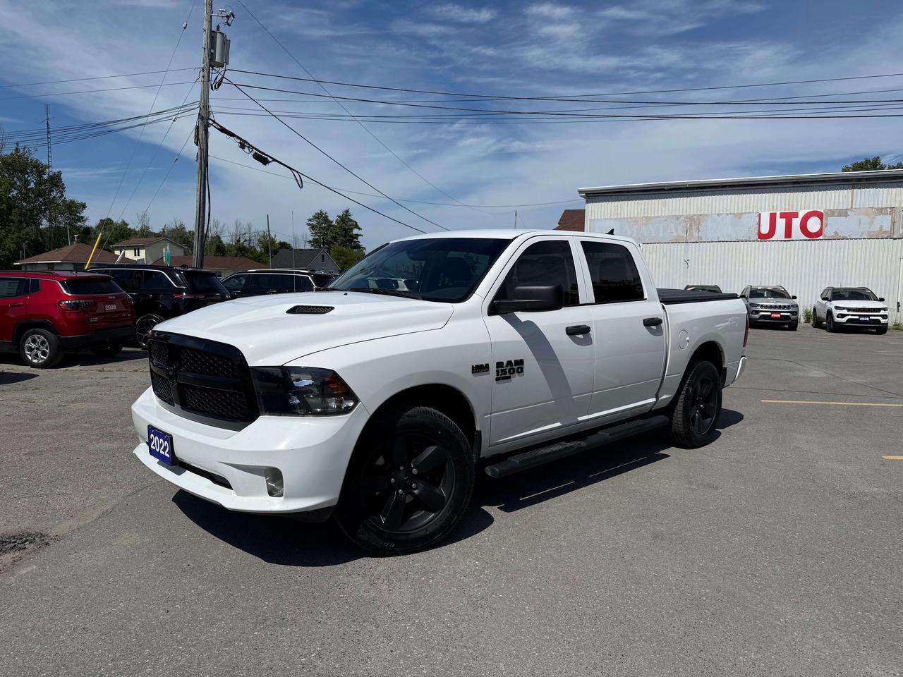 2022 RAM 1500 CLASSIC EXPRESS 4X4 CREW CAB.  5.7L HEMI ENGINE WITH 3.92 REAR AXLE RATIO.  8.4" SCREEN WITH APPLE CARPLAY OR ANDROID AUTO, REMOTE START, HEATED SEATS & STEERING WHEEL, POWER DRIVER SEAT, MOPAR SIDE STEPS, TRAILER BRAKE CONTROLLER, MOPAR SPRAY IN BEDLINER, TRI-FOLD TONNEAU COVER, DUAL ZONE CLIMATE CONTROL, LED BED LIGHTING, ANTI-SPIN DIFFERENTIAL REAR AXLE, REAR PARK ASSIST SYSTEM, MOPAR FRONT & REAR ALL WEATHER MATS, & MORE!  ONLY HST EXTRA.