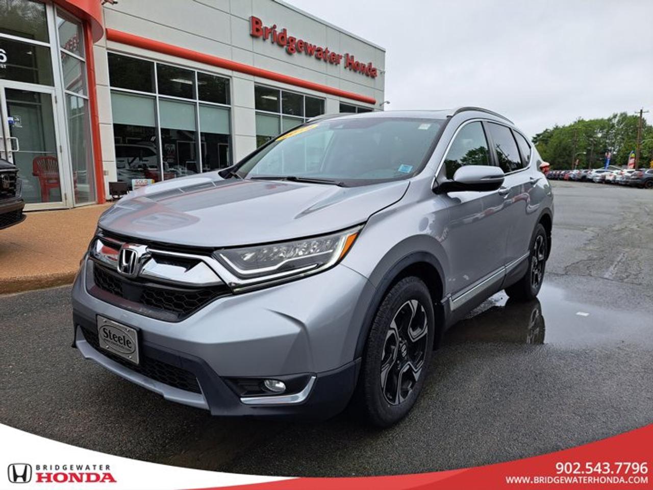 2018 Honda CR-V Touring AWDEnjoy comfort, versatility, and confidence behind the wheel with this 2018 Honda CR-V Touring AWD. With 158,011 km, this well-equipped SUV is ready for many more adventures, offering the premium features and practicality that have made the CR-V one of Canadas favourite SUVs.Powered by a fuel-efficient 1.5L turbocharged engine and equipped with Hondas Real Time AWD , the CR-V provides confident handling in all seasons. Whether youre commuting through Bridgewater, exploring the South Shore, or packing up for a weekend getaway, this CR-V has the space, comfort, and capability to keep up with your lifestyle.HighlightsReal Time AWDLeather-trimmed seatingHeated front seatsHeated steering wheelPower drivers seat with memoryApple CarPlay® & Android AutoBuilt-in navigationPower tailgatePower moonroofDual-zone automatic climate controlHonda Sensing® safety technologiesRemote startMulti-angle rearview cameraBuy With ConfidenceEvery pre-owned vehicle at Bridgewater Honda includes:Fresh oil changeNova Scotia MVISafety inspectionProfessional detailCARFAX Vehicle History ReportFull tank of fuelRecent ServiceThis CR-V has received:Four new tiresNew front brake pads and rotorsNew front brake caliperNova Scotia Motor Vehicle Inspection (MVI)This vehicle has experienced two previous accidents, both of which were professionally repaired. It has been thoroughly inspected by our technicians and is ready for the road.Quality You Can TrustWhile this CR-V is not Steele Certified, it has successfully passed our inspection process to ensure it meets our standards for safety and reliability, allowing you to purchase with confidence.Financing AvailableBridgewater Honda offers financing options for all credit situations. Whether youre rebuilding credit, buying your first vehicle, or looking for affordable monthly payments, our finance team is here to help.Proudly serving drivers in Bridgewater, the South Shore, and across Nova Scotia, Bridgewater Honda is committed to providing quality pre-owned vehicles and exceptional customer service.Book your test drive, reserve this 2018 Honda CR-V Touring AWD online, or apply for financing today!