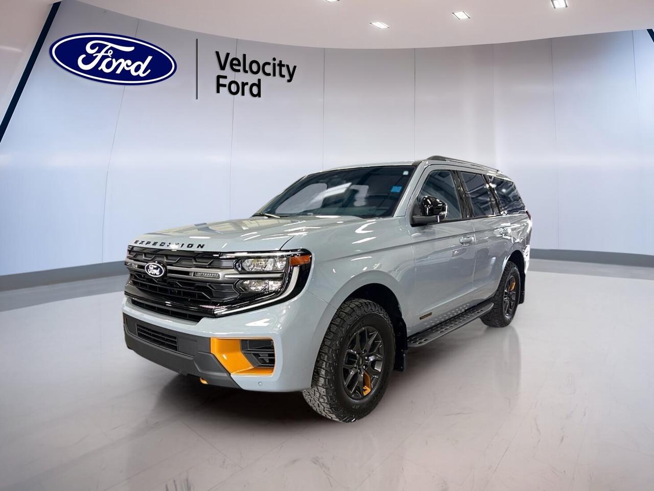 The 2027 Ford Expedition Tremor 4x4 is a brand new full-size SUV built for families, travel, and rougher roads. Offered by Velocity Ford in Moose Jaw, it pairs bold Grey paint with a Black interior, four doors, and a strong 3.5-litre unleaded engine with automatic transmission.

This 2027 Ford Expedition Tremor 4x4 blends everyday comfort with trail-ready confidence. Four-wheel drive, off-road tires, a limited slip differential, side steps, and a rear tow hook help it handle changing conditions with ease. Inside, you get a refined cabin with useful tech, roomy seating, and smart convenience features.

FEATURES OF THE Expedition Tremor 4x4
»» Off-road tires support loose-surface driving confidence
»» Four-wheel drive adds traction on rough terrain
»» Rear tow hook boosts recovery versatility
»» Side steps aid easy cabin access

ADVANCED SAFETY FEATURES
»» Anti-lock braking helps maintain steering control
»» Stability control supports secure road handling
»» Backup camera assists while reversing carefully
»» Blind spot monitor adds lane-change awareness

PERFORMANCE AND EFFICIENCY
»» 3.5-litre unleaded engine delivers strong output
»» Automatic transmission provides smooth gear changes
»» Limited slip differential improves off-road traction
»» Four-wheel drive handles varied surface conditions

COMFORT AND CONVENIENCE
»» Heated front and rear seats add comfort
»» Dual-zone climate control helps balance temperatures
»» Remote starter warms cabin before departure
»» Power liftgate improves daily loading ease

TECHNOLOGY AND CONNECTIVITY
»» Navigation system helps guide every journey
»» Bluetooth integration supports hands-free communication
»» WiFi hotspot keeps passengers better connected
»» Steering wheel audio controls simplify access

CARGO SPACE
»» Full-size SUV shape offers generous cargo room
»» Power liftgate helps with busy loading
»» Four-door layout improves passenger and cargo access
»» Spacious rear area suits family travel

WHAT OTHER OWNERS LIKE
»» Smooth power for highway merging confidence
»» Spacious cabin for passengers and gear
»» Useful technology that feels easy to use
»» Strong traction in snow and mud

The 2027 Ford Expedition Tremor 4x4 also adds premium touches that make long drives easier. Heated mirrors, electric mirrors, retractable mirrors, power windows, tinted windows, automatic headlights, fog lights, LED headlamps, and turn signal mirrors all support comfort and visibility in daily driving around Moose Jaw and beyond.

Inside, this 2027 Ford Expedition Tremor 4x4 is equipped for comfort with front air conditioning, rear air conditioning, rear climate control, automatic climate control, push button start, memory seats, memory mirrors, drivers seat lumbar support, passenger lumbar support, an adjustable steering wheel, and an auto-dimming rearview mirror. The panoramic sunroof and glass sunroof bring in extra light and a more open feel.

Entertainment and convenience are also well covered in this 2027 Ford Expedition Tremor 4x4. Satellite radio, HD Radio, Bluetooth integration, navigation, and a WiFi hotspot help keep every trip connected and enjoyable. Safety is supported by driver and passenger airbags, side impact airbags, head side airbags, child safety locks, lane departure warning, tire pressure monitoring, and automatic door locks.

This 2027 Ford Expedition Tremor 4x4s VIN is: 1FMJU1RGXVEA00804.