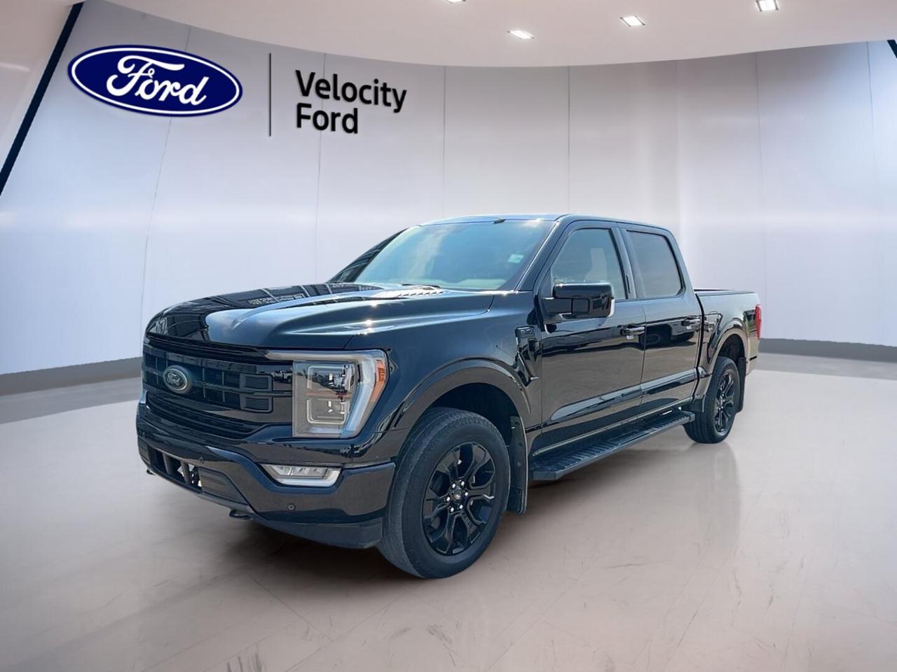 Built for work, travel, and daily comfort, this used 2022 Ford F-150 LARIAT 4WD SuperCrew 5.5 Box with Sport FX4, Trailer Tow, & Black Appearance Pkg delivers strong V8 power, confident four-wheel drive, and a bold black-on-black look. Offered by Velocity Ford in Moose Jaw, it has 50,226 km, four doors, and an automatic transmission for easy, capable driving.

With its 5.0-litre unleaded V8 engine, this truck gives you proven strength for towing, hauling, and highway passing. The SuperCrew cab adds excellent room for passengers, while the 5.5-foot box keeps cargo practical for both jobsite use and weekend gear. This F-150 LARIAT 4WD SuperCrew 5.5 Box with Sport FX4, Trailer Tow, & Black Appearance Pkg is well equipped with the features you want most.

FEATURES OF THE F-150 LARIAT 4WD SuperCrew 5.5 Box With Sport FX4, Trailer Tow, & Black Appearance Pkg
»» Black Appearance Package adds bold exterior accents
»» FX4 package supports off-road driving confidence
»» Trailer Tow Package boosts hauling capability
»» 5.0-litre V8 delivers proven truck power

TRUCK FEATURES
»» Tows up to 4,717 kg confidently
»» Four-wheel drive supports rough road traction
»» 5.5-foot box handles daily cargo needs
»» Rear tow hook adds utility support

ADVANCED SAFETY FEATURES
»» Backup camera helps with reversing visibility
»» Blind spot monitor adds lane awareness
»» Lane departure warning supports safer travel
»» Side and head airbags increase protection

PERFORMANCE AND EFFICIENCY
»» 5.0-litre unleaded V8 offers strong output
»» Automatic transmission delivers smooth shifting response
»» Four-wheel drive improves traction in weather
»» Stability control helps maintain road confidence

COMFORT AND CONVENIENCE
»» Heated front seats add cold-weather comfort
»» Dual-zone climate control keeps temperatures balanced
»» Remote starter helps prepare the cabin
»» Memory seats support repeat driver comfort

TECHNOLOGY AND CONNECTIVITY
»» Navigation system helps guide every trip
»» Bluetooth integration supports hands-free communication
»» WiFi hotspot keeps devices connected
»» Steering wheel audio controls ease access

CARGO SPACE
»» SuperCrew cabin offers flexible passenger room
»» Rear trunk access supports easy loading
»» Spare tire adds roadside peace of mind
»» Power windows help with quick ventilation

AWARDS & RECOGNITIONS
»» North American Truck of the Year, North American Car, Truck and Utility Vehicle of the Year, 2021
»» Best Full-Size Pickup in Quality, J.D. Power, 2022

WHAT OTHER OWNERS LIKE
»» Strong V8 performance for towing confidence
»» Spacious SuperCrew cabin for family comfort
»» User-friendly technology for daily driving ease
»» Confident ride with four-wheel drive traction

This truck also adds useful everyday equipment that makes life easier in every season. Heated mirrors, electric mirrors, retractable mirrors, tinted windows, automatic headlights, fog lights, LED headlamps, rear window defroster, push button start, and automatic door locks all help create a convenient and capable ownership experience.

Inside, the black interior feels refined and functional. Front air conditioning, automatic climate control, adjustable pedals, an adjustable steering wheel, a leather steering wheel, ambient lighting, drivers seat lumbar support, passenger lumbar support, power driver and passenger seating, and an auto-dimming rearview mirror help make longer drives more comfortable.

Entertainment and information are also well covered. Satellite radio, HD Radio, and a clear infotainment setup work well with Bluetooth integration and built-in navigation. Cruise control and power steering help reduce effort on long highway trips, while the backup camera adds confidence when parking or lining up a trailer.

For drivers who want a well-equipped full-size pickup with real capability, this used 2022 Ford F-150 LARIAT 4WD SuperCrew 5.5 Box with Sport FX4, Trailer Tow, & Black Appearance Pkg stands out as a smart choice at Velocity Ford in Moose Jaw.

This 2022 Ford F-150 LARIAT 4WD SuperCrew 5.5 Box With Sport FX4, Trailer Tow, & Black Appearance Pkgs VIN is: 1FTFW1E52NFB25508.