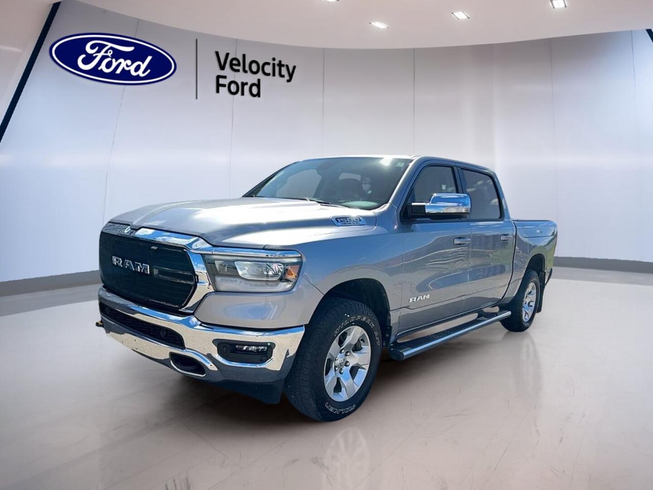 Built for hard work and daily comfort, this used 2021 RAM 1500 Big Horn 4x4 Crew Cab 57 Box brings strong V8 power, a smooth 8-speed automatic transmission, and the confidence of four-wheel drive. Finished in Silver with a Brown interior, it has 42,612 km and a practical four-door Crew Cab layout.

At Velocity Ford in Moose Jaw, this 2021 RAM 1500 Big Horn 4x4 Crew Cab 57 Box stands out with a balanced mix of capability, easy-to-use tech, and proven durability. Its 5.7-litre unleaded engine supports confident towing up to 5,152 kg, while the short box helps keep this full-size truck easy to manage in town.

FEATURES OF THE 1500 Big Horn 4x4 Crew Cab 57 Box

»» Bold Big Horn design and presence
»» Crew Cab adds roomy rear seating
»» 57 box supports daily versatility
»» 4x4 traction for changing road conditions

TRUCK FEATURES

»» Tows up to 5,152 kg confidently
»» Rear tow hook adds jobsite utility
»» Four-wheel drive supports off-road traction
»» Short box helps urban manoeuvrability

ADVANCED SAFETY FEATURES

»» Backup camera helps with safer reversing
»» Anti-lock brakes support controlled stopping
»» Stability control adds handling confidence
»» Side and head airbags enhance protection

PERFORMANCE AND EFFICIENCY

»» 5.7-litre unleaded V8 delivers strong output
»» Eight-speed automatic shifts smooth and quick
»» Power steering supports easy daily handling
»» Cruise control helps on highway trips

COMFORT AND CONVENIENCE

»» Front air conditioning keeps cabin comfortable
»» Push button start adds everyday ease
»» Power windows simplify driver control
»» Heated mirrors help in cold weather

TECHNOLOGY AND CONNECTIVITY

»» Bluetooth integration supports hands-free calling
»» Steering wheel audio controls reduce distraction
»» Automatic headlights respond to light changes
»» Illuminated vanity mirror adds convenience

CARGO SPACE

»» 57 box handles gear with ease
»» Crew Cab adds secure interior storage
»» Rear trunk access supports loading convenience
»» Spare tire adds roadside peace

AWARDS & RECOGNITIONS

»» 2021 Truck of Texas, Texas Auto Writers Association
»» Best Full-Size Truck, AutoTrader, 2021

WHAT OTHER OWNERS LIKE

»» Smooth ride for a full-size truck
»» Strong HEMI V8 towing confidence
»» Spacious Crew Cab for family use
»» User-friendly controls and clear layout

This RAM is equipped with useful details that make a difference every day. Heated and power-adjustable mirrors, retractable mirrors, tinted windows, fog lights, turn signal mirrors, and automatic door locks all add convenience. The leather-wrapped steering wheel and adjustable steering column help create a comfortable driving position.

Safety and peace of mind are supported by driver and passenger airbags, a passenger airbag sensor, child safety locks, tire pressure monitoring, and a backup camera. With its solid capability, practical equipment, and comfortable cabin, this truck is ready for work, travel, and daily driving in every season.

This 2021 RAM 1500 Big Horn 4x4 Crew Cab 57 Boxs VIN is: 1C6SRFFT3MN673125.
