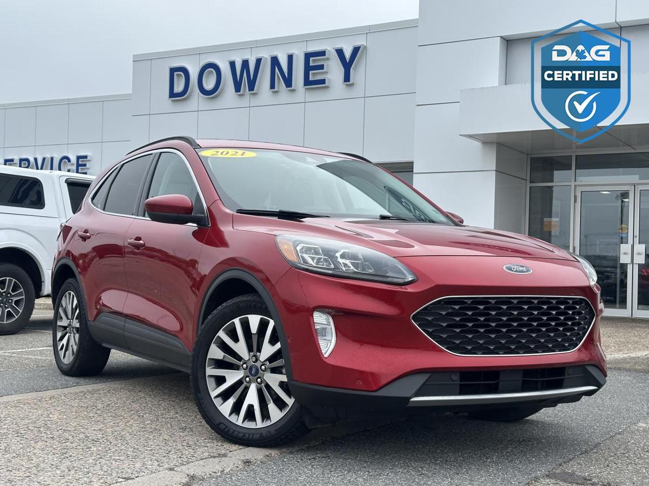 200 combined horsepower, exceptional fuel efficiency, and intelligent all-wheel drive make this 2021 Ford Escape Titanium Hybrid the perfect SUV for drivers who want premium comfort without compromising on performance or economy. Combining advanced hybrid technology with luxury features and cutting-edge safety, this Escape is built for todays lifestyle.

Powered by a sophisticated 2.5L Atkinson-cycle hybrid powertrain, this Escape produces a combined 200 horsepower while delivering outstanding fuel economy. Paired with Fords electronically controlled continuously variable transmission (eCVT) and intelligent AWD system, it provides smooth acceleration, quiet operation, and confident traction in all weather conditions. Whether youre commuting through the city or heading out on a weekend getaway, youll appreciate fewer stops at the fuel pump without sacrificing capability.

As the top-of-the-line Titanium trim, this Escape is exceptionally well equipped. The upscale interior features leather-trimmed seating, heated front seats, a heated steering wheel, power-adjustable front seats with memory settings, dual-zone automatic climate control, remote start, push-button start, a panoramic Vista Roof, wireless charging, and a hands-free power liftgate. The spacious cabin and flexible cargo area make it an excellent choice for families, commuters, and active lifestyles.

Technology is another standout feature. Equipped with Fords SYNC 3 infotainment system, this Escape includes an intuitive touchscreen display with Apple CarPlay and Android Auto compatibility, Bluetooth connectivity, voice-activated controls, navigation, a premium B&O sound system by Bang & Olufsen, multiple USB ports, and FordPass Connect with a built-in Wi-Fi hotspot capability. Everything is designed to keep you connected and comfortable wherever the road takes you.

Safety is equally impressive thanks to Ford Co-Pilot360 Assist+. Advanced features include Adaptive Cruise Control with Stop-and-Go, Pre-Collision Assist with Automatic Emergency Braking, Blind Spot Information System, Rear Cross-Traffic Alert, Lane Keeping System, Evasive Steering Assist, Rear View Camera, Active Park Assist 2.0, and Auto High-Beam Headlamps. These intelligent systems help provide added confidence on every drive.

The exterior is sleek and modern, featuring LED lighting, premium alloy wheels, chrome accents, and a refined design that gives the Escape Titanium a sophisticated appearance. With its outstanding fuel economy, premium amenities, advanced safety, and proven hybrid technology, this 2021 Ford Escape Titanium Hybrid AWD delivers an exceptional ownership experience.

Why buy from Downey Ford? GREAT QUESTION!! Heres why: Market Value Pricing provides the most competitive prices on all our pre-owned vehicles, all the time! Downey Ford is the largest volume Ford dealership in the Maritimes. Every Pre-Owned Vehicle comes with New Wipers, New In-Cabin Filter, and New Engine Air Filter. Plus Plus Plus.

Reconditioning our pre-owned inventory is a source of pride for us! A basic motor vehicle inspection and a quick wash just isnt good enough for our customers. We complete an extremely thorough process, both mechanically and cosmetically, before it meets our standards.

Our mechanical inspection covers 100+++ components including the Engine, Electrical System, Suspension, Transmission, Brakes, Frame, and regular maintenance servicing. Our cosmetic reconditioning is elite and includes Shampooing of Carpet, Acid Wash of Rims, Dressing of Tires, Engine Detail, and a Multi-Stage Polish.

Here are some other extras we are happy to offer at no charge to you: Vehicle History Report, Accident / Damage Report, Stolen Vehicle Report, Lien Search Report, Credit Report Review and Counseling, Free Trade-In Appraisals, Relaxed Low Pressure Sales Experience, Finance Pre-Approval Service, Service Departments covering ALL of Southern New Brunswick, Delivery Services to all of Canada, Multiple Chartered Bank Financing Sources, Multiple Vehicle Protection Products available, Multiple Loan Protection Products available, and a Pet-Friendly Facility. Feel free to bring Bingo with you.

We want to EARN your business and hope to speak with you soon. Our knowledgeable and friendly sales staff are here to ensure a seamless and enjoyable car-buying experience. Call us at 506-632-6000 to book your test drive today and discover why Downey Ford is the trusted choice for so many.
200 combined horsepower, exceptional fuel efficiency, and intelligent all-wheel drive make this 2021 Ford Escape Titanium Hybrid the perfect SUV for drivers who want premium comfort without compromising on performance or economy. Combining advanced hybrid technology with luxury features and cutting-edge safety, this Escape is built for todays lifestyle.

Powered by a sophisticated 2.5L Atkinson-cycle hybrid powertrain, this Escape produces a combined 200 horsepower while delivering outstanding fuel economy. Paired with Fords electronically controlled continuously variable transmission (eCVT) and intelligent AWD system, it provides smooth acceleration, quiet operation, and confident traction in all weather conditions. Whether youre commuting through the city or heading out on a weekend getaway, youll appreciate fewer stops at the fuel pump without sacrificing capability.

As the top-of-the-line Titanium trim, this Escape is exceptionally well equipped. The upscale interior features leather-trimmed seating, heated front seats, a heated steering wheel, power-adjustable front seats with memory settings, dual-zone automatic climate control, remote start, push-button start, a panoramic Vista Roof, wireless charging, and a hands-free power liftgate. The spacious cabin and flexible cargo area make it an excellent choice for families, commuters, and active lifestyles.

Technology is another standout feature. Equipped with Fords SYNC 3 infotainment system, this Escape includes an intuitive touchscreen display with Apple CarPlay and Android Auto compatibility, Bluetooth connectivity, voice-activated controls, navigation, a premium B&O sound system by Bang & Olufsen, multiple USB ports, and FordPass Connect with a built-in Wi-Fi hotspot capability. Everything is designed to keep you connected and comfortable wherever the road takes you.

Safety is equally impressive thanks to Ford Co-Pilot360 Assist+. Advanced features include Adaptive Cruise Control with Stop-and-Go, Pre-Collision Assist with Automatic Emergency Braking, Blind Spot Information System, Rear Cross-Traffic Alert, Lane Keeping System, Evasive Steering Assist, Rear View Camera, Active Park Assist 2.0, and Auto High-Beam Headlamps. These intelligent systems help provide added confidence on every drive.

The exterior is sleek and modern, featuring LED lighting, premium alloy wheels, chrome accents, and a refined design that gives the Escape Titanium a sophisticated appearance. With its outstanding fuel economy, premium amenities, advanced safety, and proven hybrid technology, this 2021 Ford Escape Titanium Hybrid AWD delivers an exceptional ownership experience.

Why buy from Downey Ford? GREAT QUESTION!! Heres why: Market Value Pricing provides the most competitive prices on all our pre-owned vehicles, all the time! Downey Ford is the largest volume Ford dealership in the Maritimes. Every Pre-Owned Vehicle comes with New Wipers, New In-Cabin Filter, and New Engine Air Filter. Plus Plus Plus.

Reconditioning our pre-owned inventory is a source of pride for us! A basic motor vehicle inspection and a quick wash just isnt good enough for our customers. We complete an extremely thorough process, both mechanically and cosmetically, before it meets our standards.

Our mechanical inspection covers 100+++ components including the Engine, Electrical System, Suspension, Transmission, Brakes, Frame, and regular maintenance servicing. Our cosmetic reconditioning is elite and includes Shampooing of Carpet, Acid Wash of Rims, Dressing of Tires, Engine Detail, and a Multi-Stage Polish.

Here are some other extras we are happy to offer at no charge to you: Vehicle History Report, Accident / Damage Report, Stolen Vehicle Report, Lien Search Report, Credit Report Review and Counseling, Free Trade-In Appraisals, Relaxed Low Pressure Sales Experience, Finance Pre-Approval Service, Service Departments covering ALL of Southern New Brunswick, Delivery Services to all of Canada, Multiple Chartered Bank Financing Sources, Multiple Vehicle Protection Products available, Multiple Loan Protection Products available, and a Pet-Friendly Facility. Feel free to bring Bingo with you.

We want to EARN your business and hope to speak with you soon. Our knowledgeable and friendly sales staff are here to ensure a seamless and enjoyable car-buying experience. Call us at 506-632-6000 to book your test drive today and discover why Downey Ford is the trusted choice for so many.