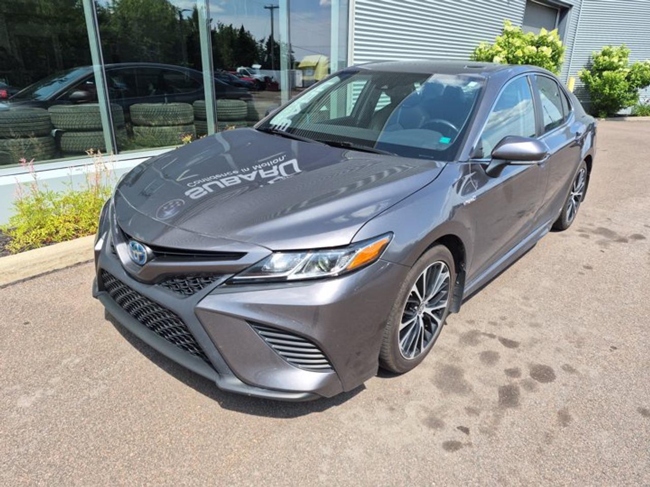 **2020 Toyota Camry Hybrid SE Sporty Style | Exceptional Fuel Economy | Advanced Safety**Enjoy the perfect combination of sporty design, outstanding fuel efficiency, and Toyotas renowned reliability with this 2020 Toyota Camry Hybrid SE. Whether youre commuting to work or heading out on a road trip, this stylish midsize sedan delivers a comfortable ride, responsive performance, and impressive hybrid efficiency.Powered by a 2.5L 4-cylinder engine paired with Toyotas Hybrid Synergy Drive®, the Camry Hybrid SE offers smooth acceleration and excellent fuel economy without compromising everyday practicality.Inside, youll find a well-appointed cabin featuring sport fabric seats with SofTex® trim, a leather-wrapped steering wheel, dual-zone automatic climate control, a power drivers seat, and a touchscreen infotainment system with Apple CarPlay®, Android Auto , Bluetooth® connectivity, and a rearview camera.Toyota Safety Sense 2.0 comes standard, providing confidence on every drive with advanced driver assistance features including Pre-Collision System with Pedestrian Detection, Lane Departure Alert with Steering Assist, Dynamic Radar Cruise Control, Lane Tracing Assist, Automatic High Beams, and Road Sign Assist.**Key Features:*** 2.5L 4-cylinder Hybrid Synergy Drive®* Automatic eCVT transmission* Sport-tuned SE suspension* Toyota Safety Sense 2.0* Apple CarPlay® & Android Auto* Bluetooth® hands-free calling and audio streaming* Touchscreen infotainment system* Rearview camera* Power drivers seat* Dual-zone automatic climate control* Leather-wrapped steering wheel with paddle shifters* Sport fabric seats with SofTex® trim* Alloy wheels* LED headlights and daytime running lights* Keyless entry with push-button startCombining exceptional fuel economy, modern technology, sporty styling, and Toyotas legendary dependability, this 2020 Toyota Camry Hybrid SE is an excellent choice for drivers seeking value, comfort, and long-term reliability. Contact us today to schedule your test drive!