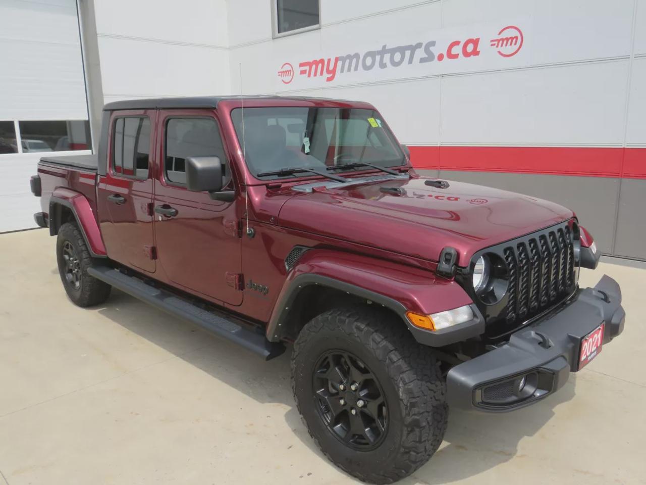 2021 Jeep Gladiator Sport | 4x4 | Automatic | Alloy Wheels | Removable Soft Top | Tow Hooks | Skid Plates | Air Conditioning | Cruise Control | Touchscreen Display | Android Auto & Apple CarPlay | USB-C Ports | Back-Up Camera | Steering Wheel Audio Controls | Heated Power Mi Photo