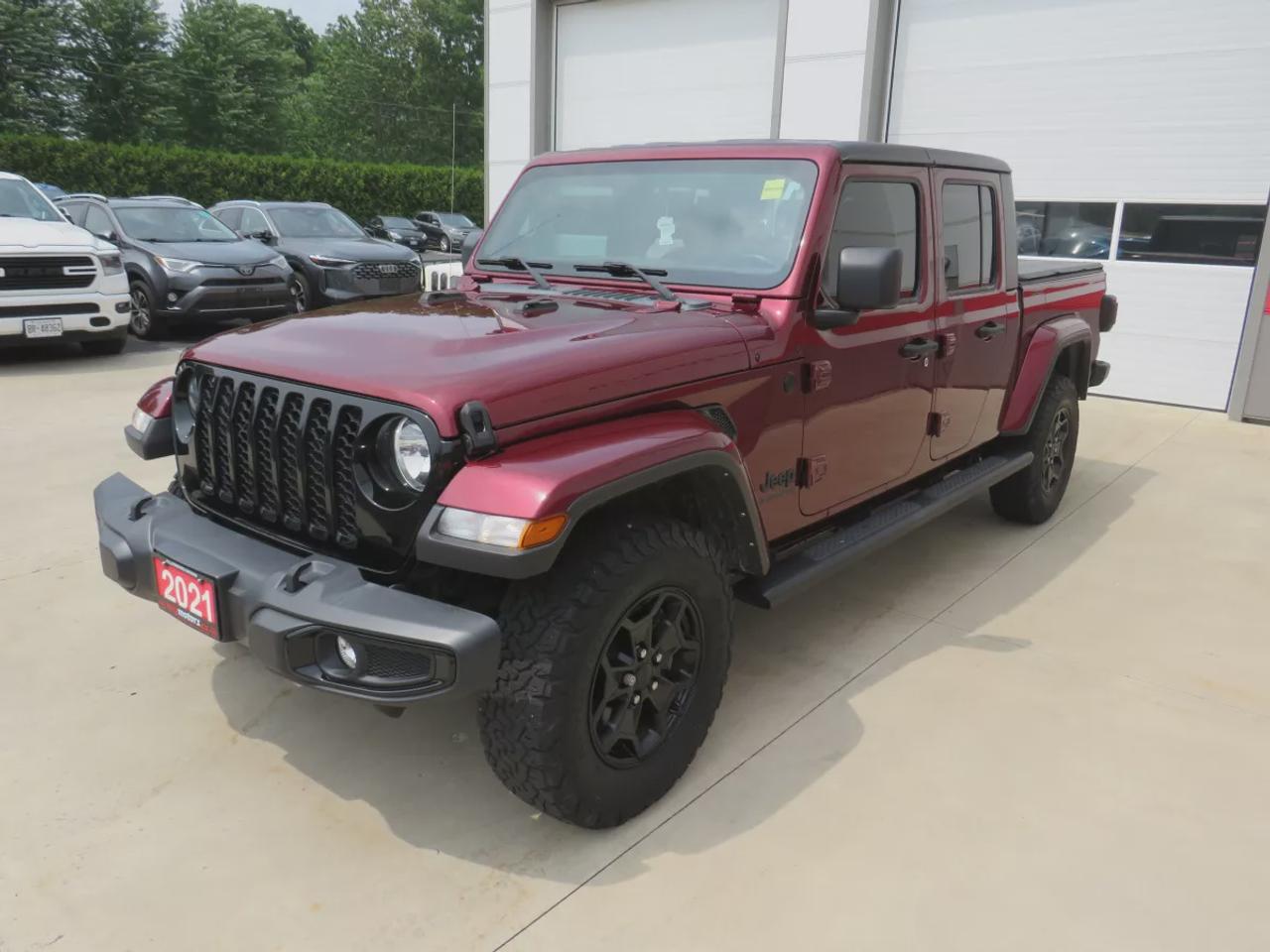 2021 Jeep Gladiator Sport | 4x4 | Automatic | Alloy Wheels | Removable Soft Top | Tow Hooks | Skid Plates | Air Conditioning | Cruise Control | Touchscreen Display | Android Auto & Apple CarPlay | USB-C Ports | Back-Up Camera | Steering Wheel Audio Controls | Heated Power Mi Photo