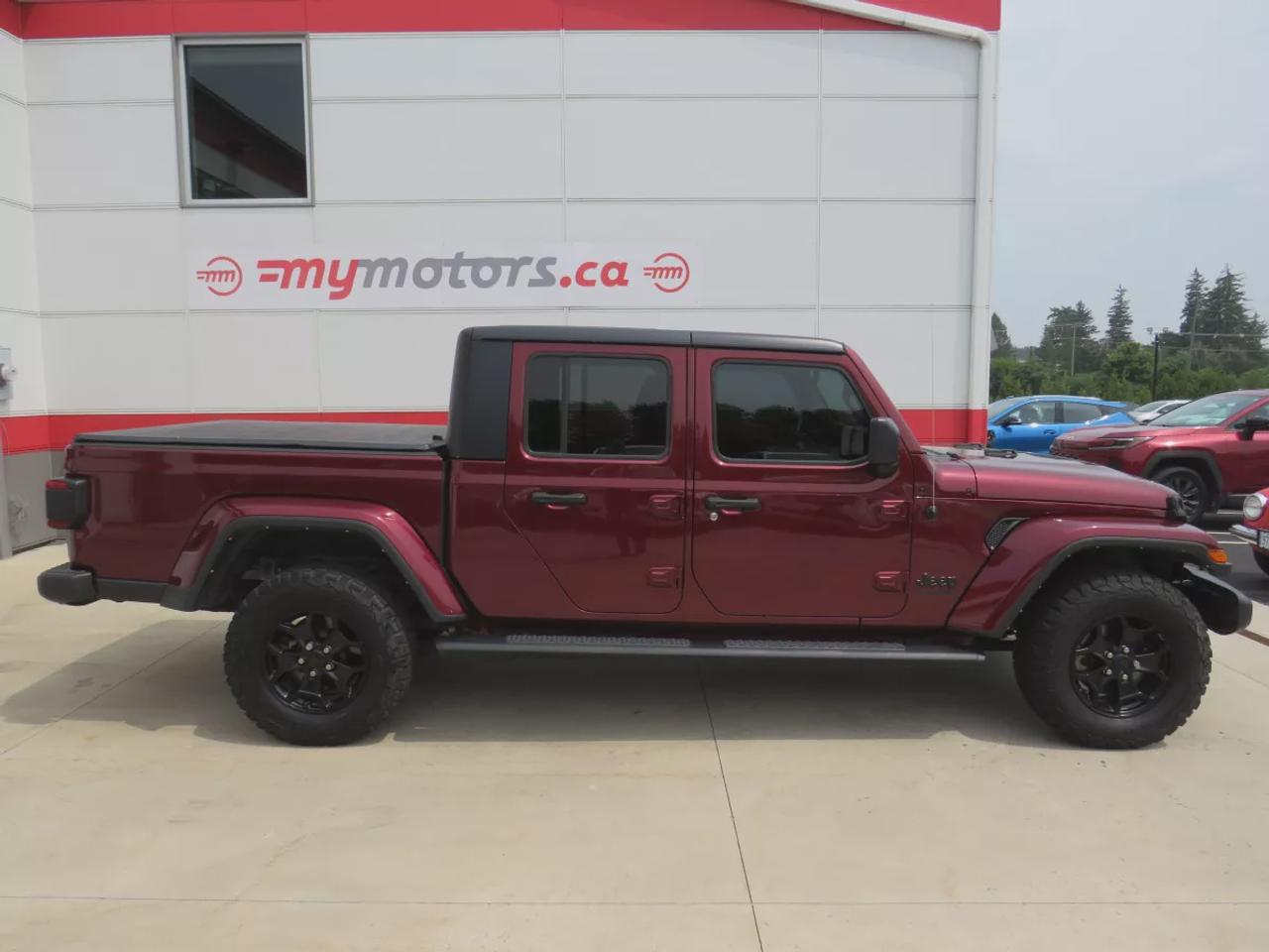 2021 Jeep Gladiator Sport | 4x4 | Automatic | Alloy Wheels | Removable Soft Top | Tow Hooks | Skid Plates | Air Conditioning | Cruise Control | Touchscreen Display | Android Auto & Apple CarPlay | USB-C Ports | Back-Up Camera | Steering Wheel Audio Controls | Heated Power Mi Photo