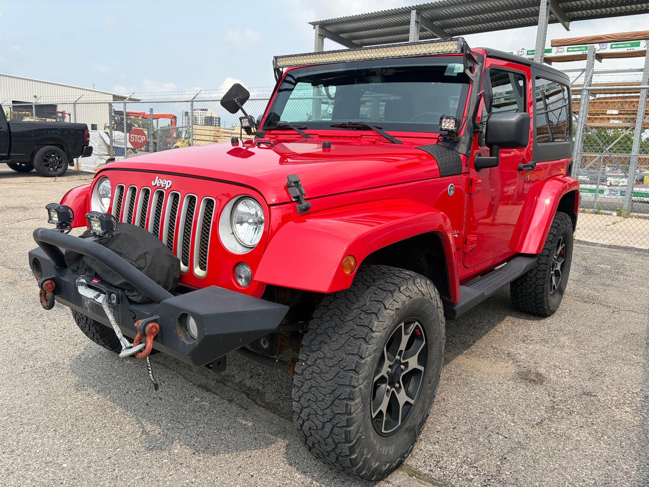 CARFAX No Reported Accidents | Front Heated Seats | Navigation System | Alpine Premium Audio w/9-Speakers & Subwoofer | Anti-Spin Rear Differential<br><br>18 x 7.5 7-Spoke Polished Aluminum Wheels, 3.21 Rear Axle Ratio, 4-Wheel Disc Brakes, 40GB Hard Drive w/28GB Available, 6.5 Touchscreen, ABS brakes, Air Conditioning, Alpine Premium Audio System, AM/FM radio, Anti-Spin Differential Rear Axle, Audio Jack Input for Mobile Devices, Auto-dimming Rear-View mirror, Black Sunrider Soft Top, Block heater, Body-Colour Grille w/Bright Accent, Brake assist, CD player, Cloth Bucket Seats, Compass, Connectivity Group, Convertible HardTop, Driver door bin, Driver vanity mirror, Dual front impact airbags, Dual Top Group, Electronic Stability Control, Electronic Vehicle Information Centre, For SiriusXM Info, Call 888-539-7474, Front anti-roll bar, Front Bucket Seats, Front Bumper Accents, Front fog lights, Front Heated Seats, Front reading lights, Fully automatic headlights, Glass rear window, GPS Navigation, Hands-Free Communication w/Bluetooth, Heated door mirrors, Heavy Duty Suspension w/Gas Shocks, Illuminated entry, Integrated roll-over protection, Leather steering wheel, Low tire pressure warning, Occupant sensing airbag, Outside temperature display, Panic alarm, Passenger door bin, Passenger vanity mirror, Power door mirrors, Power steering, Power windows, Quick Order Package 23G, Radio: 430 Nav, Rear anti-roll bar, Rear Bumper Accents, Rear window defroster, Rear window wiper, Remote keyless entry, Security system, SiriusXM Satellite Radio, Speed control, Steering wheel mounted audio controls, Tachometer, Tilt steering wheel, Tire Pressure Monitoring System, Traction control, Trip computer, Variably intermittent wipers.<br><br>Firecracker Red Clearcoat<br>2017 Jeep Wrangler Sahara<br>2D Sport Utility<br>Pentastar 3.6L V6 VVT 6-Speed Manual<br>4WD<br><br>Awards:<br>  * 2017 KBB.com 10 Most Awarded Brands   * 2017 KBB.com 10 Most Awarded Cars   * 2017 KBB.com 10 Best SUVs Under $25,000   * 2017 KBB.com Best Resale Value Awards   * 2017 KBB.com 10 Coolest Cars Under $25,000   * 2017 KBB.com 10 Most Fun SUVs