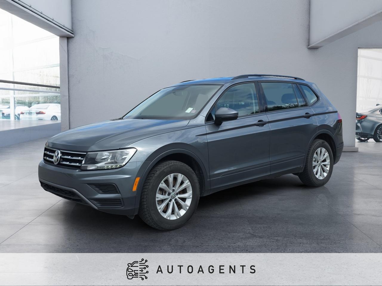 <p>Finished in sophisticated Grey, this 2020 Volkswagen Tiguan Trendline 4MOTION delivers the perfect combination of practicality, comfort, and all-weather capability. Powered by a responsive <strong>2.0L Turbocharged TSI 4-cylinder gasoline engine</strong> paired with an <strong>8-speed automatic transmission with Tiptronic</strong> and Volkswagens renowned <strong>4MOTION All-Wheel Drive</strong>, this versatile SUV offers confident handling, impressive fuel efficiency, and the flexibility your lifestyle demands. Whether youre navigating city streets or heading out on your next adventure, the Tiguan Trendline is built to handle it all with confidence.</p><p><strong>Key Features:</strong></p><ul data-spread=false><li>2.0L Turbocharged TSI 4-Cylinder Gasoline Engine</li><li>8-Speed Automatic Transmission with Tiptronic</li><li>4MOTION All-Wheel Drive (AWD)</li><li>Drive Mode Selection</li><li>Engine Start/Stop System</li><li>17-Inch Alloy Wheels</li><li>LED Daytime Running Lights</li><li>Automatic Headlights</li><li>Heated Power Exterior Mirrors</li><li>Roof Rails</li><li>Heated Front Seats</li><li>Premium Cloth Seating</li><li>Leather-Wrapped Multi-Function Steering Wheel</li><li>40/20/40 Split-Folding Rear Seats</li><li>Air Conditioning</li><li>Cruise Control</li><li>Remote Keyless Entry</li><li>6.5-Inch Touchscreen Infotainment System</li><li>Apple CarPlay</li><li>Android Auto</li><li>Bluetooth Hands-Free Connectivity</li><li>USB Connectivity</li><li>Rearview Backup Camera</li><li>Blind Spot Monitor</li></ul><p>Combining Volkswagens legendary German engineering with a spacious cabin, advanced safety features, and dependable 4MOTION capability, this 2020 Tiguan Trendline is an excellent choice for families, commuters, and anyone looking for a stylish, fuel-efficient SUV thats ready for every season. <span>Dont waitthis exceptional vehicle wont last long! Stop by our dealership today and take it for a test drive to experience its performance, comfort, and features firsthand. Our friendly and knowledgeable sales agent is ready to answer your questions, walk you through every feature, and help you find the perfect vehicle for your lifestyle.</span></p><p>We offer flexible financing solutions tailored to your budget, along with a variety of comprehensive extended warranty options to help protect your investment and provide long-term peace of mind. Our finance specialists will work with you to create a financing and protection plan that fits your individual needs and goals.</p><p>Visit us today and discover why so many customers choose us for their next vehicle. We look forward to welcoming you, introducing you to your dedicated sales consultant, and helping you drive away with confidence in your next vehicle!</p>