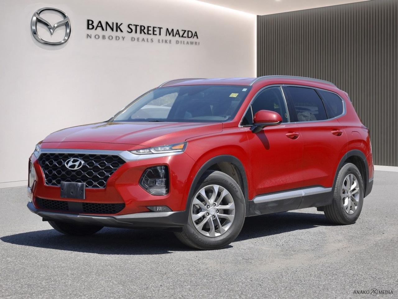 Introducing the 2019 Hyundai Santa Fe Essential in a striking color that enhances its dynamic silhouette and front-wheel drive for agile city maneuvering. This SUV radiates confidence with its sleek alloy wheels and a robust SUV build that promises to turn heads wherever you go. Step inside to find a thoughtfully crafted interior where comfort meets functionality. Enjoy the convenience of air conditioning, while the heated seats ensure a warm ride even on the coldest days. The leather-wrapped steering wheel and heated mirrors add an extra touch of luxury to your journey. Modern technology is at your fingertips with smart device integration, Bluetooth connection, and an intuitive backup camera for seamless connectivity and ease of navigation. Safety is prioritized with features like adaptive cruise control, lane assist, and brake assist, ensuring peace of mind on every trip. Perfect for adventurous families or individuals looking for comfort with a touch of luxury, the 2019 Hyundai Santa Fe Essential offers a refined driving experience. Contact Bank Street Mazda today to learn more about this exceptional SUV and schedule a test drive.