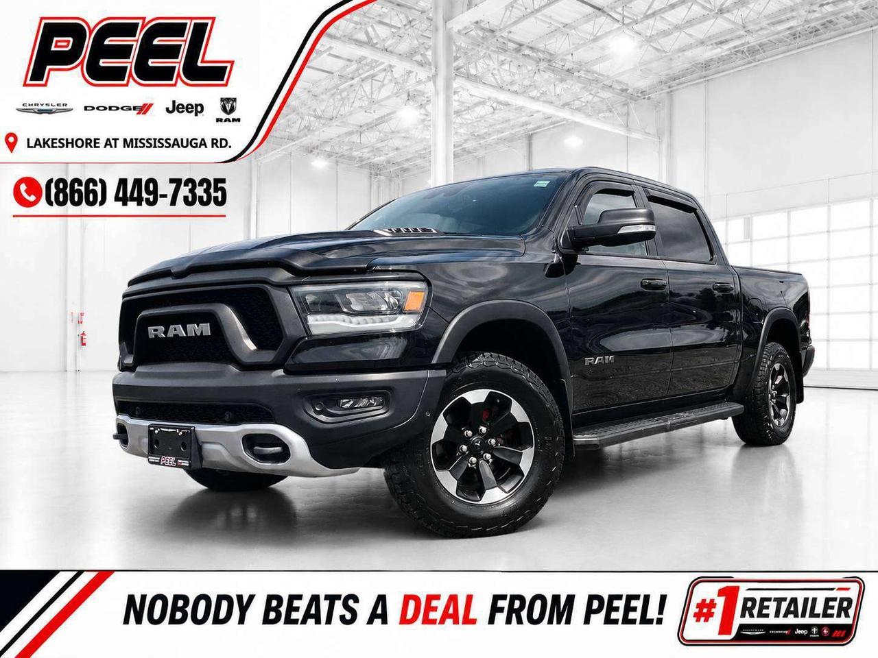 COME SEE WHY NOBODY BEATS A DEAL FROM PEEL! Your Source for ALL make and models used cars and trucks.

2022 Ram 1500 Rebel Crew Cab 4X4 | 5.7L HEMI V8 | Diamond Black Crystal Pearl | Black/Red Cloth & Vinyl Bucket Seats | Level 2 Equipment Group | Heated Front Seats | Heated Steering Wheel | Remote Start | Uconnect 5 NAV w/ 12" Touchscreen Display | 9-speaker Amplified Audio System w/ Subwoofer | Wireless Apple CarPlay & Android Auto | Sport Performance Hood | Forward Collision Warning | Park-sense Front & Rear Parking Sensors | ParkView Rear Back-up Camera | Mopar Black Tubular Side Steps | Spray-in Bed Liner | Soft Tri-fold Tonneau Cover | Class IV Hitch Receiver | E-Locker Electronic Locking Rear Differential | 3.92 Rear Axle Ratio

This 2022 Ram 1500 Rebel comes finished in Diamond Black Crystal Pearl and is powered by the legendary 5.7L HEMI V8, giving you the sound, power, and classic Mopar character that make these trucks so desirable. The aggressive Rebel styling looks especially sharp in Diamond Black, with the Sport Performance Hood, black and red interior, and Mopar black tubular side steps giving this truck plenty of presence. Inside, heated cloth and vinyl bucket seats, a heated steering wheel, remote start, and the massive 12-inch Uconnect 5 touchscreen with navigation, wireless Apple CarPlay and Android Auto make it comfortable and easy to enjoy every day. It is also already equipped with the practical extras most truck owners end up adding themselves, including a spray-in bed liner, soft tri-fold tonneau cover, and Mopar side steps. With a Class IV hitch receiver, 3.92 rear axle ratio, E-Locker electronic locking rear differential, and Trailer Sway Control, this Rebel Crew Cab HEMI has the right hardware for towing, traction, and real truck use. Finished with Forward Collision Warning, Park-sense Front & Rear Parking Sensors, and a ParkView Rear Back-up Camera, this is a great-looking Rebel with the right mix of V8 power, comfort, technology, and utility.
______________________________________________________

FREE CarFax included! Click the CarFax link in the listing to view the report.

Our advertised prices are for consumers/end users only and are not intended for dealer, wholesale, exporter, or broker purchases.
______________________________________________________

Peel Chrysler is based in Port Credit, Mississauga, and proudly serves customers across Ontario and Canada, including Toronto, Oakville, North York, Richmond Hill, Ajax, Hamilton, Niagara Falls, Brampton, Scarborough, Vaughan, London, Windsor, Cambridge, Kitchener, Waterloo, Brantford, Sarnia, Pickering, Huntsville, Milton, Woodbridge, Aurora, Newmarket, Orangeville, Georgetown, Markham, North Bay, Sudbury, Barrie, Oshawa, Kingston, Innisfil, and surrounding areas. Browse our selection of used cars, trucks, SUVs, vans, Ram, Jeep, Dodge, Chrysler, FIAT, and all makes and models at peelchrysler.com.
______________________________________________________

Disclaimer: Prices are for consumer/end-user purchases only. Advertised prices are all-in and include all dealer fees and charges, including the $499 loan processing fee where applicable, except HST, Fuel and Licensing, unless otherwise stated. Payments, rates, and terms are subject to approved credit and may change without notice. If a trade-in has an outstanding loan balance and Peel Chrysler is required to facilitate the lien payout, a $349 lien payout fee applies. Most pre-owned vehicles originally come with two keys; however, all Peel Chrysler pre-owned vehicles come standard with one key unless otherwise stated. Vehicle images may be digitally adjusted or enhanced for presentation purposes and may not always reflect the exact appearance of the vehicle. While we make every effort to ensure accuracy, vehicle details, features, options, materials, history, specifications, pricing, availability, and CarFax information should be verified with Peel Chrysler before purchase.