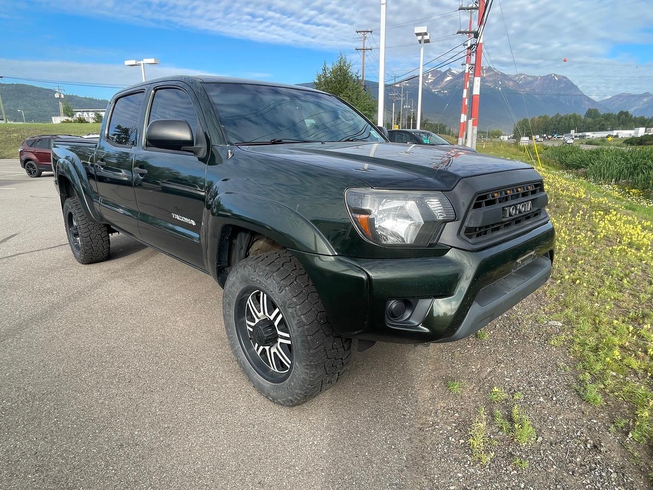 <p>Looking for a rugged and reliable truck that can handle anything you throw at it? Smithers Toyota has the perfect solution: a pre-owned 2013 Toyota Tacoma. This 4-wheel drive pickup truck is built to last, boasting a powerful 4.0L V6 engine and a 5-speed automatic transmission, ready for both your daily commute and your weekend adventures. With its spacious interior, including rear seat heater ducts and ample cup holders, its designed for comfort for you and your passengers, no matter the journey. This Tacoma has 255,865 kilometers on the odometer, a testament to its enduring quality and the care it has received.</p><p>&nbsp;</p><p>This 2013 Toyota Tacoma is more than just a truck; its a capable workhorse and a dependable companion. The composite cargo bed, complete with tie-down points and cleats, is ready to haul your gear, while the removable tailgate offers versatile access. For those who venture off the beaten path, the 2-speed transfer case with an auto-disconnecting differential and a limited slip rear differential provide enhanced traction and control. Plus, with features like front tow hooks and a full-size spare tire, youll be prepared for whatever the road, or lack thereof, throws your way.</p><p>&nbsp;</p><p>Here are 5 features that make this 2013 Toyota Tacoma truly stand out:</p><p><br><br></p><ul><li><strong>4.0L DOHC SMPI 24-valve V6 Engine with VVT-i:</strong> Experience robust power and intelligent performance from this legendary V6 engine, designed for both capability and efficiency.</li></ul><p>&nbsp;</p><ul><li><strong>4-Wheel Drive with 2-Speed Transfer Case & Limited Slip Rear Differential:</strong> Conquer any terrain with confidence, thanks to a drivetrain engineered for superior traction and control in challenging conditions.</li></ul><p>&nbsp;</p><ul><li><strong>Composite (SMC) Cargo Bed with 6 Length, Tie-Down Points & Cleats:</strong> Haul your equipment with ease and security in this durable and versatile cargo bed, built to withstand the demands of work and play.</li></ul><p>&nbsp;</p><ul><li><strong>Independent Double-Wishbone Front Suspension with Bilstein Gas Shocks:</strong> Enjoy a smooth and controlled ride, even on rough roads, thanks to a premium suspension system that enhances handling and comfort.</li></ul><p>&nbsp;</p><ul><li><strong>Roll-Sensing Front/Rear Head/Side Curtain Airbags & Active Front Headrests:</strong> Drive with peace of mind, knowing you and your passengers are protected by a comprehensive suite of advanced safety features designed for maximum security.</li></ul><p><br><br></p><p><strong><em>Powered by AutoIntelligence&trade;</em></strong></p><p>&nbsp;</p><p>Vehicle information has been generated using artificial intelligence and is provided for informational purposes only. While efforts are made to ensure accuracy, please confirm all details directly with the dealer.</p><p>&nbsp;</p>