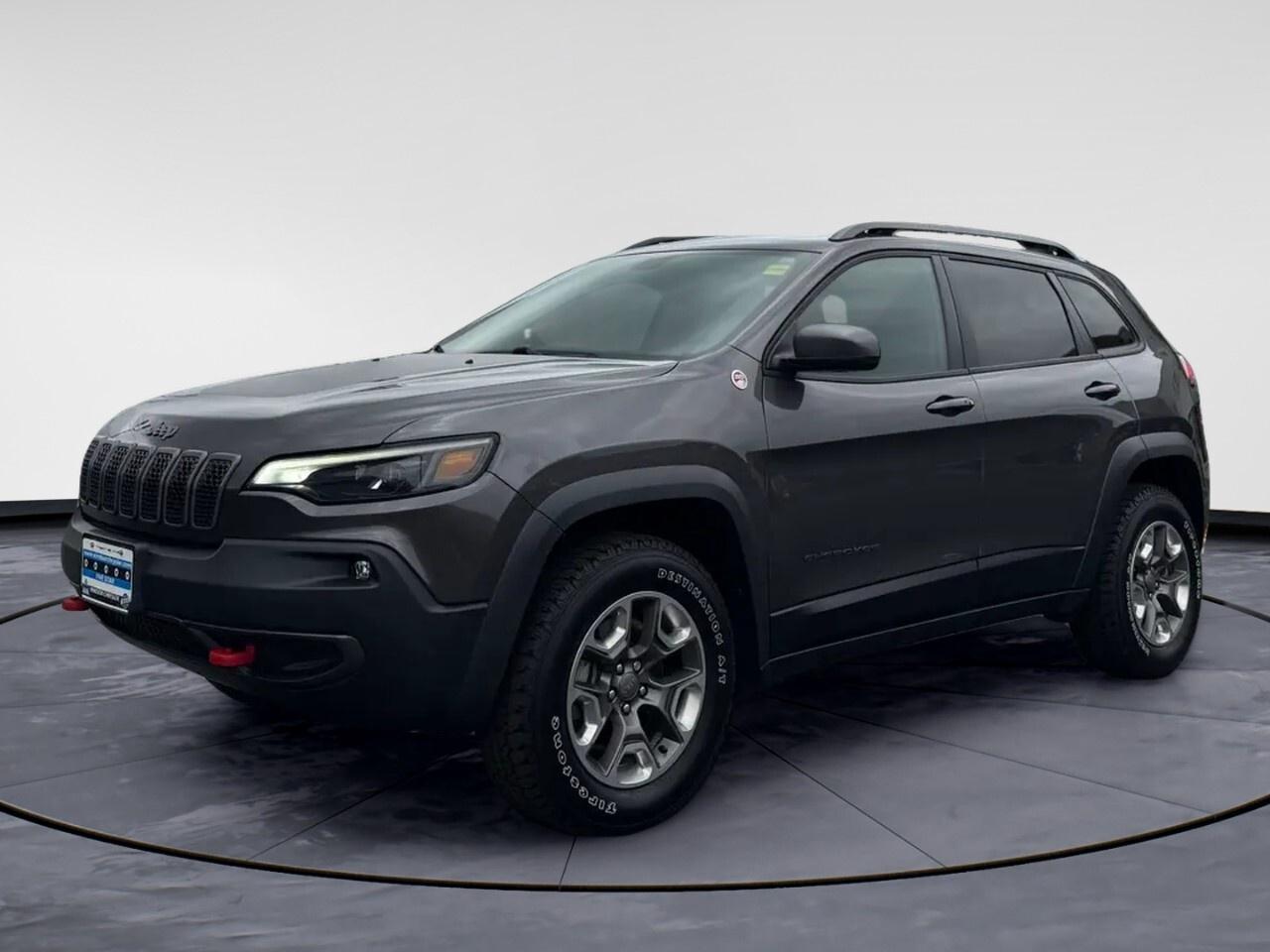 Experience the unmatched excellence of the 2019 Jeep Cherokee Trailhawk Elite, a standout SUV in a sophisticated gray finish with a robust 4x4 drivetrain. Its designed to conquer any terrain with confidence and poise.

The exterior is equipped with striking alloy wheels and a modern design that demands attention. Step inside to find a thoughtfully crafted interior that features a Leather Steering Wheel and Leather Gear Shifter Material, ensuring a premium driving experience. Convenience is key, with power windows and keyless entry enhancing your daily commute.

Stay connected and secure with the advanced technology this Jeep offers. The SUV comes with a backup camera for optimal safety and parking ease, while smart device integration and Bluetooth connection keep you linked to the digital world. With brake assist and cruise control, you can enjoy peace of mind on every journey. Plus, enjoy your favorite tunes on the satellite radio as you tackle the roads.

Perfect for adventure enthusiasts or the safety-conscious family looking for a reliable and luxurious ride, this Cherokee is ready to exceed your expectations. Contact Windsor Chrysler today for more information or to schedule a test drive, and see for yourself the performance and comfort it offers.