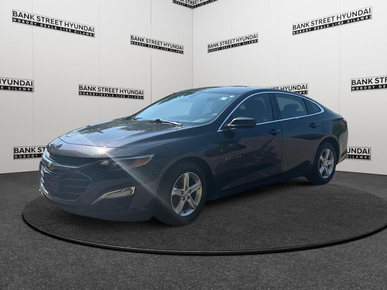 Introducing the 2022 Chevrolet Malibu LS in a stunning blue finish, expertly crafted to complement its front-wheel drive configuration for exceptional handling. This elegant sedan boasts sophisticated alloy wheels and a meticulously designed exterior that turns heads on every drive. Inside, youll find a spacious interior equipped for comfort and convenience, with thoughtful touches like air conditioning, power windows, and an intuitive keyless entry system. The blend of style and functionality continues with plush seating and generous cargo space. Stay connected on the go with smart device integration and a Wi-Fi hotspot, ensuring that you and your passengers are entertained and informed. The 2022 Malibu LS doesnt skimp on safety, featuring a reliable backup camera and advanced brake assist technology for added peace of mind. With Bluetooth connectivity and cruise control, every journey is enjoyable and effortless. Perfectly suited for families or commuters who value efficiency, comfort, and style, this vehicle is ready to be your daily driver. Contact Bank Street Hyundai today for more information on how to make this incredible sedan yours!