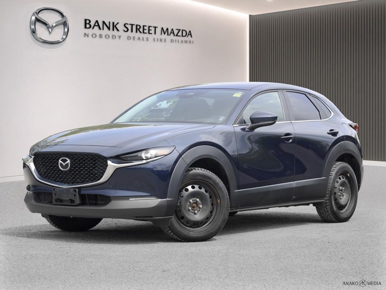 Experience the thrill of driving the 2024 Mazda CX-30 GS AWD in a stunning blue finish. This automatic, all-wheel drive SUV offers exceptional handling, ensuring youre ready for any journey. The exterior features stylish alloy wheels and the convenience of heated mirrors, making it perfect for Canadian weather. Slip inside to find a sophisticated interior with luxurious leatherette door trim and a leather/metal-look gear shifter. The cars seating is not only comfortable but practical, boasting heated front seats and a leather steering wheel, all designed to elevate your driving experience. Modern technology comes standard, including a backup camera, Bluetooth connection, and smart device integration for seamless connectivity on the go. Prioritize safety with advanced features such as lane assist, adaptive cruise control, keyless entry, and brake assist. Enjoy additional comfort with a heated steering wheel, while power windows add convenience at your fingertips. This SUV is perfect for families and solo adventurers alike, offering practicality with a touch of luxury. Contact Bank Street Mazda today to learn more and take this remarkable vehicle for a test drive.