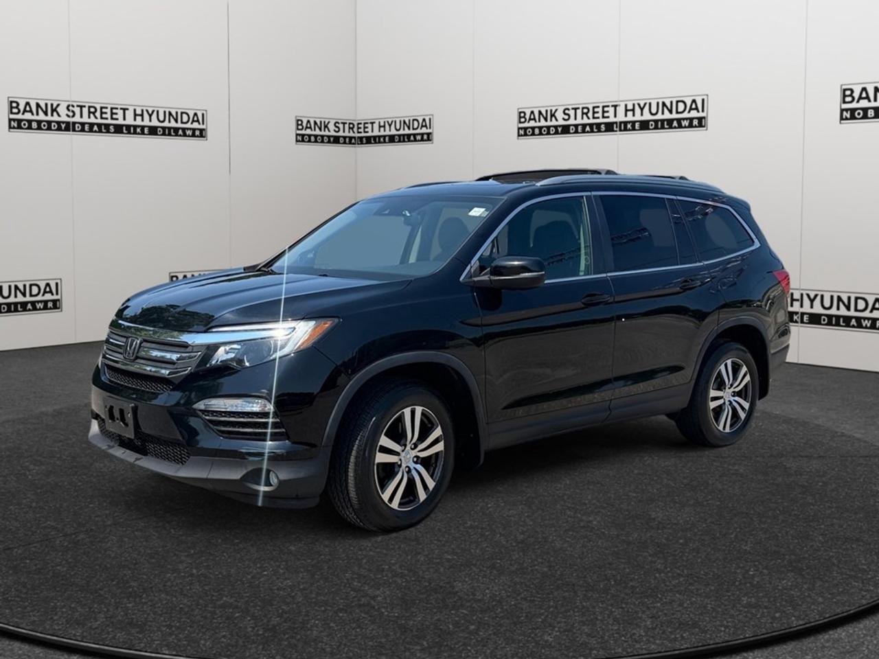 The 2018 Honda Pilot EX AWD in striking black offers a blend of performance and style with its robust all-wheel drive system ready to handle Canadian terrains. Designed with a sleek SUV body type, this vehicle delivers comfortable cruising with its efficient automatic transmission. Step inside to discover a spacious interior fitted with modern features. The abundance of room provided by the third-row seating ensures that you and your passengers can enjoy every journey in ultimate comfort. The stylish sunroof/moonroof adds a touch of luxury, allowing you to soak up the sunshine or embrace the night sky. Equipped with cutting-edge technology, the Honda Pilot includes Bluetooth connectivity, smart device integration, and a Wi-Fi hotspotperfect for staying connected on the road. Safety is a top priority, demonstrated by its backup camera, brake assist, lane assist, and adaptive cruise control for a secure and smooth ride. The remote start function enhances convenience on those cold winter mornings. With features like heated seats, power seats, and keyless entry catering to your comfort and convenience, the Honda Pilot is an exceptional choice for families and adventure enthusiasts alike. Contact Bank Street Hyundai for more details and to experience this feature-rich vehicle firsthand.