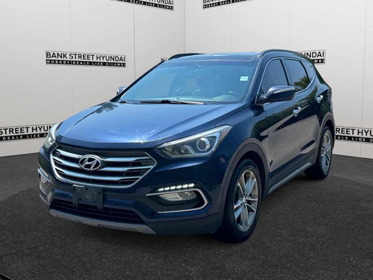 This stunning 2018 Hyundai Santa Fe Sport 2.0T Limited AWD in a captivating blue is designed to handle any terrain with ease, offering an all-wheel-drive system ideal for Canadian weather. The SUVs exterior features eye-catching alloy wheels and a sunroof, making every drive an enjoyable experience. Inside, youll find luxurious leather seats that are heated and cooled for maximum comfort, along with a leather steering wheel that adds a touch of sophistication. Equipped with the latest technology, this Santa Fe Sport boasts a robust navigation system and a smart device integration feature to keep you connected on the go. Safety is paramount with features like a backup camera, parking sensors, brake assist, lane assist, and keyless entry providing peace of mind. Perfect for families or adventurers alike, this vehicle comes packed with features designed to make every journey extraordinary. Contact Bank Street Hyundai today to learn more about making this exceptional SUV yours!