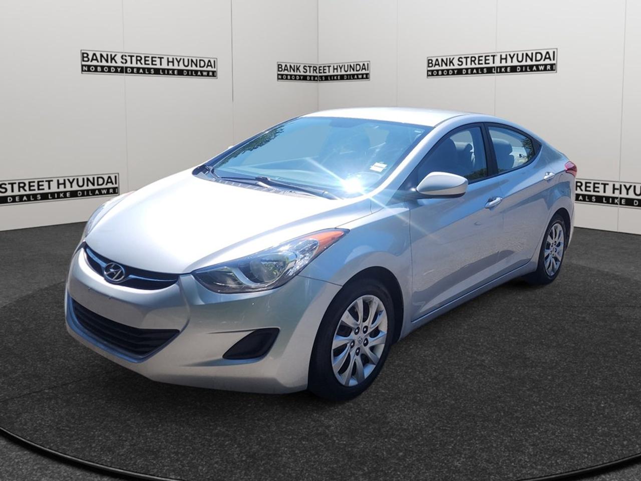 Introducing the 2013 Hyundai Elantra GL in a sophisticated gray finish with a smooth front-wheel drive experience perfect for Canadian roads. This reliable sedan not only offers impressive handling but also showcases striking exterior lines and a well-crafted design. Step inside to find a meticulously designed interior featuring comfortable heated seats and user-friendly controls. The stylish yet practical layout is complemented by an array of practical features, including convenient keyless entry and power windows for enhanced comfort and accessibility. Stay connected and safe on every journey with advanced technology like the Bluetooth connection and satellite radio, ensuring entertainment and communication are always within reach. The Elantra GL is also equipped with essential safety features such as brake assist and cruise control, providing peace of mind through every drive. Ideal for commuters and families alike, this versatile sedan combines efficiency with comfort, appealing to those who value reliability and style. Contact Bank Street Hyundai today to learn more about this charming Elantra and take it for a test drive!
