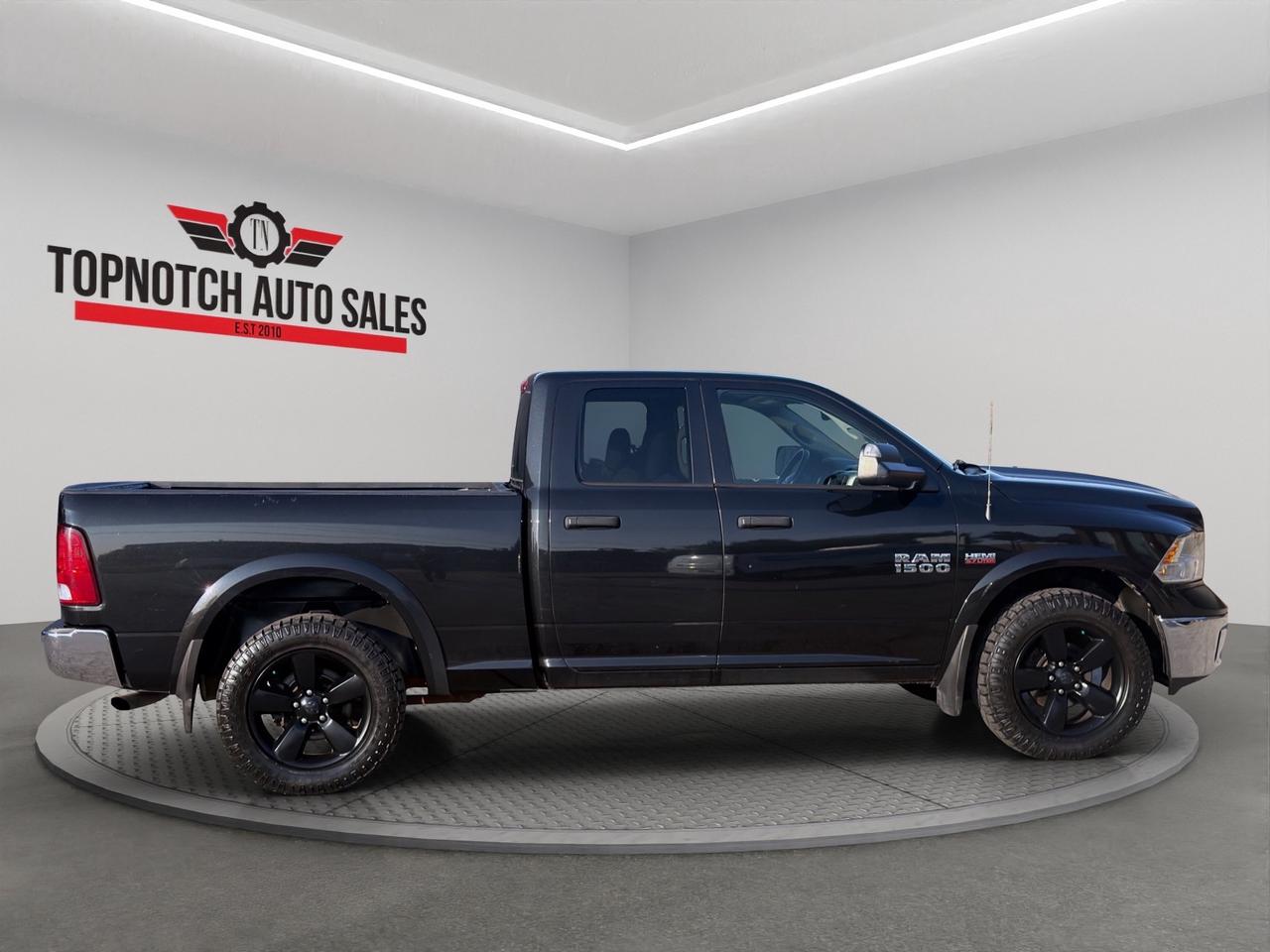 2016 RAM 1500 4WD Quad Cab 140.5" Outdoorsman Photo