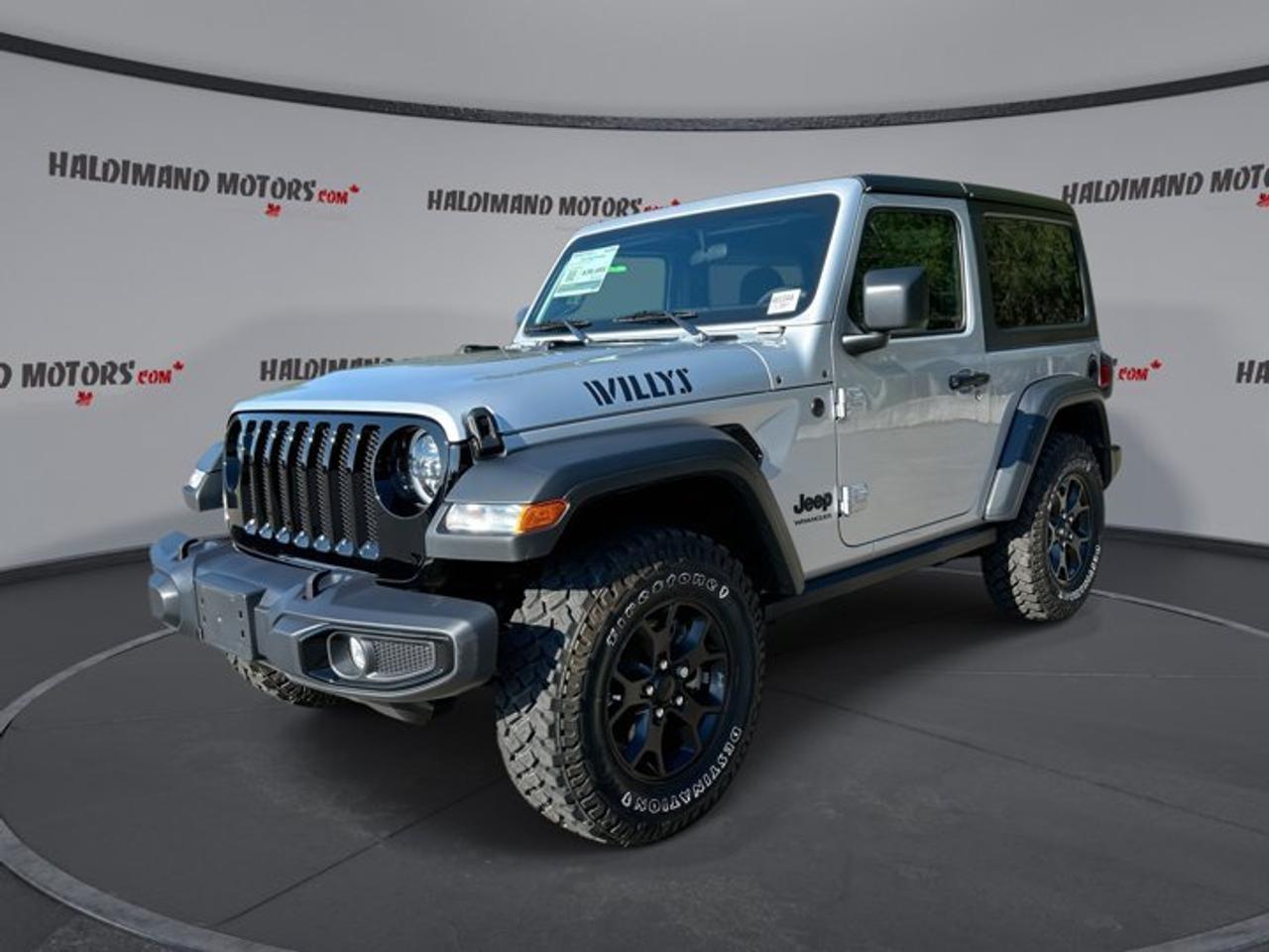 Built for open-air freedom and real trail ability, this used 2023 Jeep Wrangler 2 Door Willys 4x4 brings classic Jeep character with smart everyday comfort. Finished in Silver with a Black interior, it pairs rugged style with a responsive 2.0-litre gas engine, automatic transmission, and just 28,651 km.<br /><br />At Haldimand Motors Ltd. in Cayuga, this 2023 Jeep Wrangler 2 Door Willys 4x4 stands out with its compact 2-door body, removable-roof convertible design, and confident four-wheel drive traction. The heated steering wheel adds welcome comfort in cold Canadian weather, while off-road tires and a rear tow hook reinforce its adventure-ready purpose.<br /><br />FEATURES OF THE Wrangler 2 Door Willys 4x4 | Heated Steering Wheel<br /><br />   Willys trim adds trail-focused rugged character<br />   Four-wheel drive supports capable off-road travel<br />   Heated steering wheel adds winter comfort<br />   Convertible design delivers open-air Jeep fun<br /><br />ADVANCED SAFETY FEATURES<br /><br />   Backup camera helps with reversing confidence<br />   Stability control supports secure road handling<br />   Anti-lock braking system aids controlled stops<br />   Side impact airbags add occupant protection<br /><br />PERFORMANCE AND EFFICIENCY<br /><br />   2.0-litre gas engine feels responsive daily<br />   Automatic transmission delivers smooth shifting performance<br />   Limited slip differential aids traction off-road<br />   Off-road tires support rough terrain grip<br /><br />COMFORT AND CONVENIENCE<br /><br />   Heated steering wheel warms cold mornings<br />   Front air conditioning keeps cabin comfortable<br />   Cruise control helps on longer drives<br />   Power windows add daily ease<br /><br />TECHNONOLGY AND CONNECTIVITY<br /><br />   Apple CarPlay supports familiar phone access<br />   Android Auto keeps apps within reach<br />   Bluetooth integration enables hands-free calling<br />   Steering wheel audio controls simplify use<br /><br />CARGO SPACE<br /><br />   Rear cargo area handles daily gear<br />   Compact body remains easy to manage<br />   Spare tire adds travel reassurance<br />   Two-door layout suits active lifestyles<br /><br />AWARDS & RECOGNITIONS<br /><br />   Best Resale Value Off-Road Utility, Kelley Blue Book, 2023<br />   Best Compact SUV for Off-Roading, AutoTrader, 2023<br /><br />WHAT OTHER OWNERS LIKE<br /><br />   Strong off-road ability in compact size<br />   Open-air convertible fun in every season<br />   Easy-to-use infotainment phone integration<br />   Comfortable driving position with solid visibility<br /><br />This used Wrangler is a great fit for drivers who want a true sport utility vehicle with classic Jeep capability. Its Silver exterior gives it a clean, rugged look, while tinted windows add privacy and style. Automatic headlights help make daily driving easier, especially when light conditions change quickly.<br /><br />Inside, the cabin keeps things simple and practical. The adjustable steering wheel helps you find a comfortable driving position, and drivers seat lumbar support adds comfort on longer trips. Power steering gives this Wrangler an easy, controlled feel in town, on the highway, and on uneven surfaces.<br /><br />This 2023 Jeep Wrangler 2 Door Willys 4x4 also includes push button start for quick getaways, a tire pressure monitoring system for added awareness, and passenger airbag sensor technology. Driver and passenger airbags work with side impact airbags to support occupant protection during daily travel.<br /><br />With its four-wheel drive system, limited slip differential, and off-road tires, this Jeep is ready for more than the daily commute. It is well suited for back roads, cottage trails, and weekend escapes. The convertible body also lets you enjoy the outdoors in a way few SUVs can match.<br /><br />For shoppers looking at used SUVs in Cayuga, this Wrangler offers a rare mix of proven capability, compact size, and modern essentials. It stays true to the Jeep formula while adding welcome features like Apple CarPlay, Android Auto, Bluetooth, a backup camera, and a heated steering wheel.<br /><br />See this adventure-ready vehicle today at Haldimand Motors Ltd. in Cayuga and discover how this 2023 Jeep Wrangler 2 Door Willys 4x4 can bring more fun, more freedom, and more confidence to every drive.<br /><br />This 2023 Jeep Wrangler 2 Door Willys 4x4 | Heated Steering Wheels VIN is: 1C4GJXAN4PW625183 .<br /><br />WHY CHOOSE US? <br /><br />Honest & Transparent Buying Experience: Weve been a trusted name in business since 1984.<br /><br />STRAIGHTFORWARD PRICING:<br />Our Advertised Price Includes:<br />>>Safety Certification (No separate fee!)<br />>>30-Day 100% Mechanical Warranty<br />>>FREE Carfax History Report.<br />>>No upcharge for paying cash.<br />(Prices Exclude HST and Licensing Fees only.)<br /><br />>>Browse 300+ vehicles all in ONE LOCATION<br /><br />EASY FINANCING: Great rates & open loans<br /><br />WE BUY CARS: Get Top Dollar for your trade-in, or sell us your vehicle for CASH! Even if you dont buy from us!<br /><br />STOP BY TODAY<br />Treat yourself - stop by Haldimand Motors Ltd. located at 42 Talbot St E, Cayuga, ON N0A 1E0 to make this car yours today!<br /><br />https://www.haldimandmotors.com/used/stock-461044.html