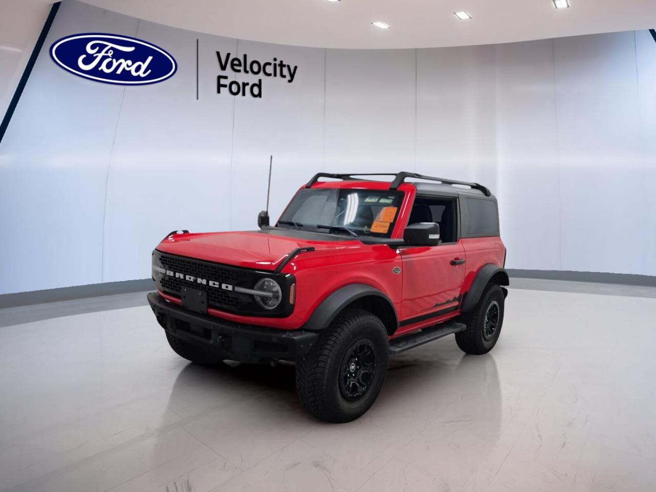 // ACCIDENT FREE!! //
// SINGLE OWNER! //

Meet the 2024 Ford Bronco WILDTRAK 2 Door 4x4 Hard Top at Velocity Ford in Moose Jaw. CARFAX Canada reports no accidents and confirms a single owner. With 59,096 km, this used SUV blends proven durability, bold style, and serious off-road talent in one exciting package.

Finished in Red with a Black interior, this 2024 Ford Bronco WILDTRAK 2 Door 4x4 Hard Top delivers a confident look with two doors, a convertible hardtop, and rugged off-road tires. Its 2.7-litre unleaded engine and automatic transmission give you strong power for daily driving and weekend escapes.

FEATURES OF THE Bronco WILDTRAK 2 Door 4x4 Hard Top
»» 2.7-litre engine delivers strong turbocharged performance
»» Convertible hardtop adds open-air driving freedom
»» Four-wheel drive supports demanding terrain conditions
»» Off-road tires boost trail-ready capability

ADVANCED SAFETY FEATURES
»» Backup camera helps with reversing confidence
»» Blind spot monitor supports safer lane changes
»» Lane departure warning adds extra awareness
»» Stability control enhances road holding security

PERFORMANCE AND EFFICIENCY
»» 2.7-litre unleaded engine provides strong output
»» Automatic transmission delivers smooth gear changes
»» Four-wheel drive improves traction off-road
»» Limited slip differential aids rough surfaces

COMFORT AND CONVENIENCE
»» Heated front seats help on cold mornings
»» Dual-zone climate control improves cabin comfort
»» Remote starter adds welcome everyday convenience
»» Power windows simplify daily operation

TECHNOLOGY AND CONNECTIVITY
»» Navigation system helps guide every trip
»» Bluetooth integration supports hands-free communication
»» WiFi hotspot keeps passengers better connected
»» Steering wheel audio controls ease use

CARGO SPACE
»» Rear trunk access simplifies loading gear
»» Two-door layout keeps cargo area practical
»» Spare tire adds peace of mind
»» Hard top protects cargo from weather

WHAT OTHER OWNERS LIKE
»» Strong power from turbocharged V6 engine
»» Confident off-road ability in tough conditions
»» Easy open-air driving with hardtop
»» Useful tech for everyday driving comfort

This Bronco is well equipped with cruise control, power steering, Anti-Lock Braking System, heated and electric mirrors, automatic headlights, LED headlamps, fog lights, tinted windows, push button start, automatic door locks, rear window defroster, and an auto-dimming rearview mirror.

You will also appreciate front air conditioning, automatic climate control, a leather steering wheel, illuminated vanity mirrors, satellite radio, passenger airbag sensor, head side airbags, side impact airbags, tire pressure monitoring, and a rear tow hook. It is built for drivers who want comfort, confidence, and real capability.

If you want a capable SUV with authentic Ford off-road character, this 2024 Ford Bronco WILDTRAK 2 Door 4x4 Hard Top is ready to impress. Visit Velocity Ford in Moose Jaw and see how this accident-free, single-owner Bronco fits your next adventure.

This 2024 Ford Bronco WILDTRAK 2 Door 4x4 Hard Tops VIN is: 1FMDE2AP3RLA33320.