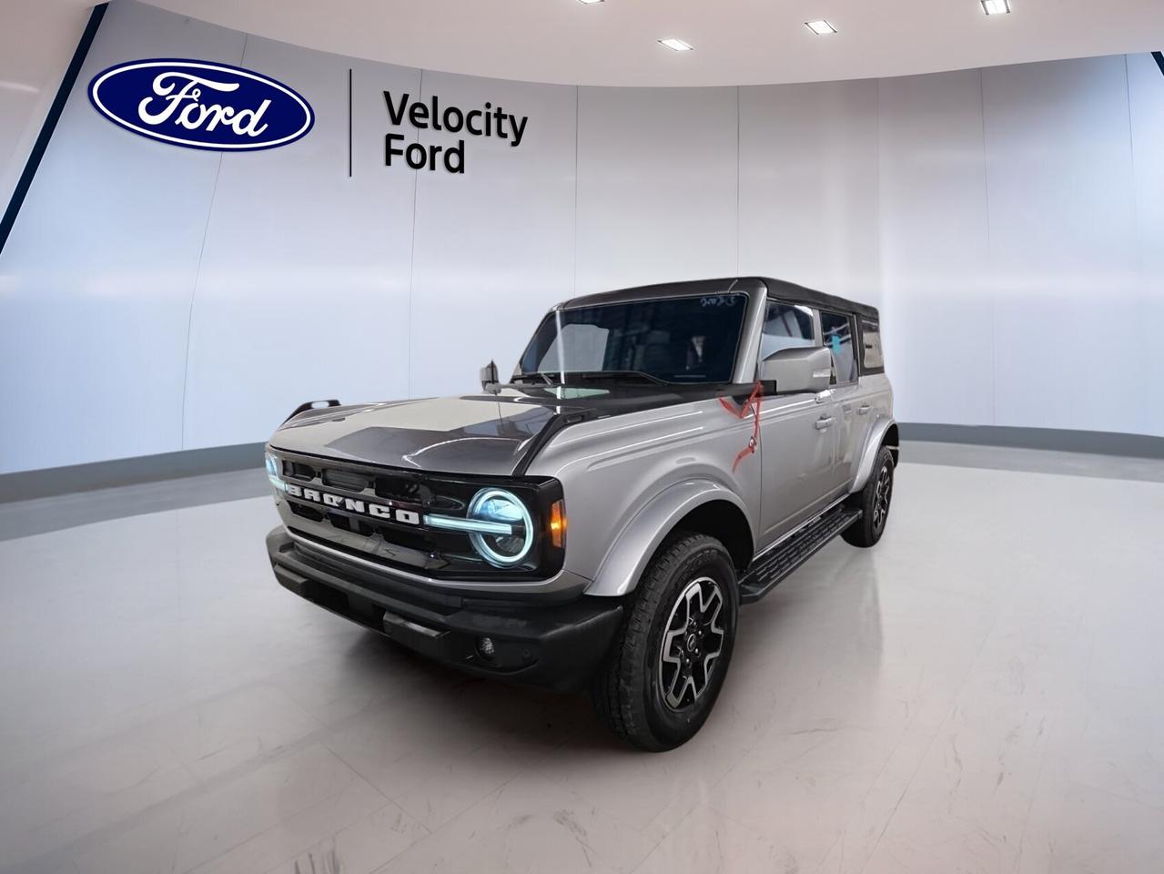 Built for open-air freedom and true trail confidence, this 2022 Ford Bronco Outer Banks 4 Door 4x4 is a capable SUV that still feels refined for daily driving. Offered by Velocity Ford in Moose Jaw, it shows only 2,165 km and pairs a Silver exterior with a Grey interior.

This used 2022 Ford Bronco Outer Banks 4 Door 4x4 features a 2.7-litre unleaded engine and automatic transmission for smooth power delivery. With four doors, four-wheel drive, off-road tires, and a convertible roof design, it is ready for city streets, highways, and weekend escapes alike.

FEATURES OF THE Bronco Outer Banks 4 Door 4x4
»» Four-door layout adds everyday practicality
»» Convertible design brings open-air adventure
»» Four-wheel drive supports off-road capability
»» 2.7-litre power delivers confident performance

ADVANCED SAFETY FEATURES
»» Backup camera helps with reversing visibility
»» Blind spot monitor adds lane awareness
»» Lane departure warning supports safer travel
»» Side and head airbags enhance protection

PERFORMANCE AND EFFICIENCY
»» 2.7-litre engine offers strong acceleration
»» Automatic transmission shifts smoothly and quickly
»» Four-wheel drive improves traction on trails
»» Off-road tires support rugged terrain travel

COMFORT AND CONVENIENCE
»» Heated front seats add cold-weather comfort
»» Dual-zone climate control helps all occupants
»» Remote starter warms cabin before driving
»» Power windows add everyday ease

TECHNOLOGY AND CONNECTIVITY
»» Navigation system helps guide every trip
»» Bluetooth integration supports hands-free calling
»» WiFi hotspot keeps devices connected
»» Steering wheel audio controls simplify use

CARGO SPACE
»» Rear trunk access helps loading gear
»» Four-door design improves passenger entry
»» Spare tire adds practical travel backup
»» Flexible SUV cabin suits daily hauling

AWARDS & RECOGNITIONS
»» North American Utility Vehicle finalist, North American Car Awards, 2022
»» Best 4x4 and Pickup, The Car Guide, 2022

WHAT OTHER OWNERS LIKE
»» Removable roof adds fun open-air driving
»» Strong engine provides confident passing power
»» Off-road ability inspires weekend exploration
»» Comfortable ride suits daily use well

The 2022 Ford Bronco Outer Banks 4 Door 4x4 blends classic utility with modern convenience in a very appealing way. This example includes cruise control, power steering, anti-lock braking system, stability control, child safety locks, heated mirrors, electric mirrors, tinted windows, satellite radio, automatic headlights, fog lights, LED headlamps, push button start, and automatic door locks.

Drivers looking for a low-kilometre SUV with real character will appreciate how this 2022 Ford Bronco Outer Banks 4 Door 4x4 balances comfort, confidence, and adventure. From heated front seats and automatic climate control to navigation and rugged four-wheel-drive capability, it is well equipped for life in Saskatchewan through every season.

This 2022 Ford Bronco Outer Banks 4 Door 4x4s VIN is: 1FMEE5BP4NLA74697.