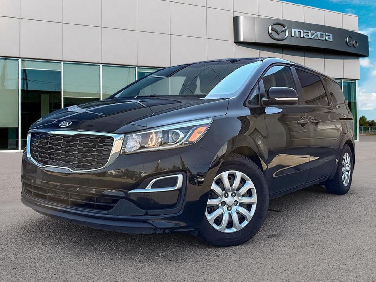 **2019 KiaSedona L(FrontWheelDrive)  Black / Gray  Fully Loaded, Ready to Go!** - **Power & Efficiency:** 3.3L GDI V6 with 8speed overdrive automatic (3.51 axle) delivers smooth, confident acceleration while staying fuelsmart. - **FamilyFocused Comfort:** Seats 7 with premium stainresistant cloth upholstery, 6way driver seat with lumbar control, 4way frontpassenger seat and splitbench 60/40 thirdrow. Allseason convenience includes reararea climate controls, heated sidemirror defrosters, and a power liftgate. - **Safety Suite:** 6 airbags, ABS + traction control, electronic stability control, hillstart assist, rearcamera and lowtirepressure alerts give peace of mind on every trip. - **Tech & Convenience:** 7inch UConnect display, steeringwheel audio controls, Bluetooth handsfree, USB charging, 3×12V power outlets, keyless entry/start and rearparking sensors. **Why It Stands Out:** The Sedonas steel wheels with lowrollingresistance tires, fully galvanized body panels, and dualbeam projectorhalogen headlights keep running costs low, while the 17inch wheelcovers and monochrome paint give a sleek urban look. With a 60month/100000km powertrain warranty and a clean, wellmaintained interior, this blackexterior, grayinterior minivan is the perfect blend of practicality, safety, and value for any growing family. **Schedule a test drive today** and experience the roomspacious, techrich ride that makes every school run, road trip, or grocery run effortless.Go Mazda is an AMVIC licensed business.Clean CarFax