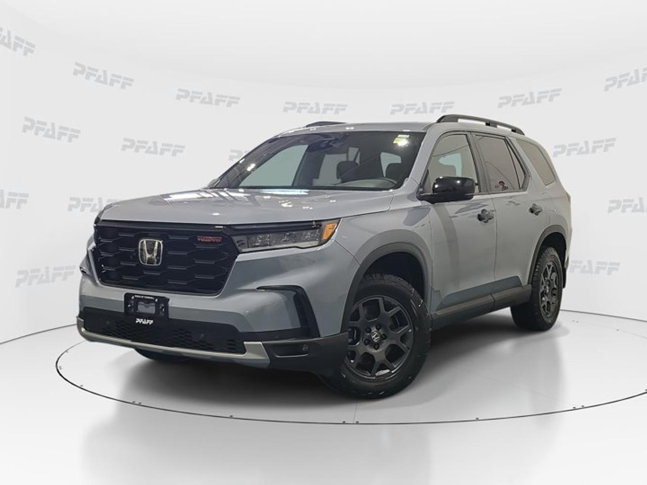 ** This disclosure applied to pre-owned inventory only: The online price includes a $1000 financing credit. For cash purchases, an additional $1000 dollars will be added to the price.*Meet the 2025 Honda Pilot Trailsport, a used SUV built for families who want confidence on city streets and cottage-bound roads alike. Finished in Grey with a Black interior, this four-door model at Honda of Thornhill shows 17,365 km and blends rugged character with smart everyday comfort.This 2025 Honda Pilot Trailsport delivers a strong, sure-footed feel with automatic transmission, practical utility, and a well-equipped cabin. Its bold stance, rear spoiler, aluminum wheels, and fog lights give this SUV a capable look, while key driver-assist and convenience features help make every trip simple and secure.FEATURES OF THE Pilot TrailsportTrail-ready design with rugged exterior detailsConfident all-terrain character for varied roadsRaised utility feel for weekend escapesSpacious SUV layout for active familiesADVANCED SAFETY FEATURESAnti-lock braking system for controlled stopsStability control supports confident handlingBlind spot monitor adds lane awarenessCross-traffic alert helps when reversingPERFORMANCE AND EFFICIENCYAutomatic transmission delivers smooth daily drivingLimited slip differential boosts tractionTraction control helps on slippery surfacesCruise control supports relaxed highway travelCOMFORT AND CONVENIENCEHeated front seats add cold-weather comfortHeated steering wheel warms winter drivesPower liftgate helps with easy loadingRemote starter adds everyday convenienceTECHNOLOGY AND CONNECTIVITYBluetooth integration supports hands-free communicationBackup camera assists with safer parkingSatellite radio expands entertainment choicesSmart device integration keeps apps accessibleCARGO SPACEFour-door access simplifies passenger entrySpare tire adds travel reassurancePower windows support quick cabin airflowFlexible cabin suits daily hauling needsAWARDS & RECOGNITIONSTop Safety Pick, Insurance Institute for Highway Safety, 2024WHAT OTHER OWNERS LIKEComfortable ride quality for long tripsStrong visibility and easy driving mannersUseful family space for passengersHelpful safety technology for daily confidenceInside, this 2025 Honda Pilot Trailsport keeps things practical and refined. You get front air conditioning, power steering, keyless entry, an adjustable steering wheel, steering wheel audio controls, a leather steering wheel, memory seats, and an auto-dimming rearview mirror. Heated mirrors and turn signal mirrors also add welcome ease in Canadian weather.Driver confidence is a major highlight in this 2025 Honda Pilot Trailsport. Adaptive cruise control, lane departure warning, child safety locks, tire pressure monitoring, automatic headlights, and a backup camera all support safer travel. These features work together to help reduce stress during commutes, school runs, and weekend highway drives.This 2025 Honda Pilot Trailsport also brings useful style and function together. The Grey exterior pairs well with the Black interior for a clean, modern look. Aluminum wheels, fog lights, and the rear spoiler add visual appeal, while HD Radio and Bluetooth integration keep every drive connected and enjoyable.Available now at Honda of Thornhill in Thornhill, this 2025 Honda Pilot Trailsport is a smart choice for drivers who want comfort, utility, and trusted Honda capability in one versatile used SUV.This 2025 Honda Pilot Trailsports VIN is: 5FNYG1H67SB512582 .