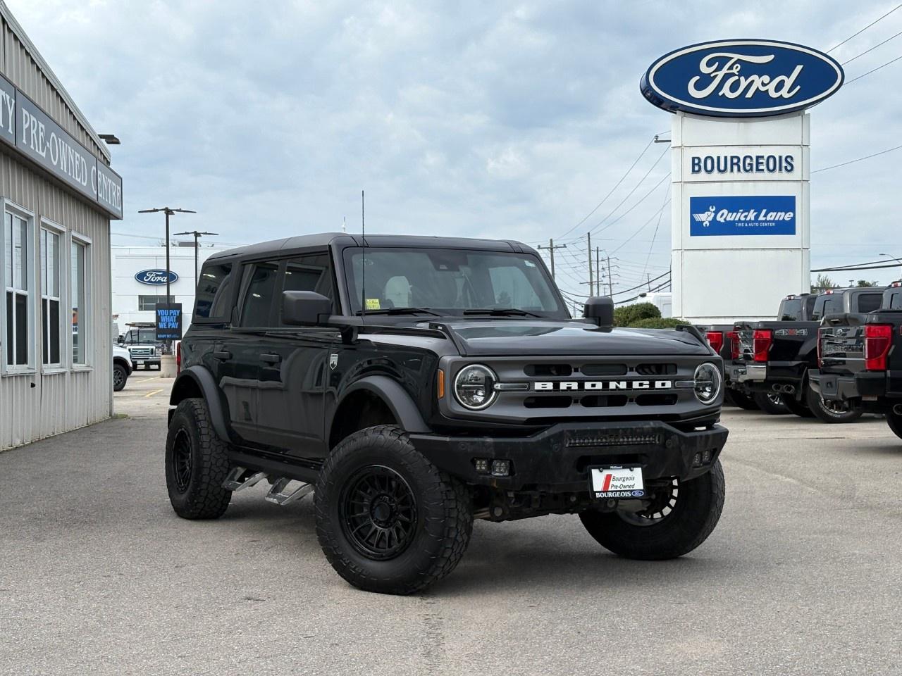 <p>Experience the adventure-ready 2024 Ford Bronco Big Bend 4 Door 4x4, dressed in an elegant black exterior and powered by the reliable ENGINE: 2.3L ECOBOOST I-4. This dynamic SUV, featuring a robust automatic transmission and 4×4 drivetrain, promises solid handling on any terrain.</p><p>Step inside to discover a comfortable gray interior, highlighted by heated mirrors and a luxurious leather steering wheel. The vehicle's design is both functional and stylish, offering an inviting atmosphere for every journey.</p><p>Stay connected and entertained with features like a Bluetooth connection, a Wi-Fi hotspot, and smart device integration. Safety and convenience are enhanced with a backup camera, brake assist, and keyless entry, ensuring peace of mind on the road.</p><p>Perfectly suited for adventurous families or off-road enthusiasts who crave both comfort and capability, this Ford Bronco Big Bend invites you to explore new horizons. Visit Bourgeois Motors Ltd. to learn more and take it for a test drive today!</p> <p><strong>Why Choose the Bourgeois Auto Group?</strong></p><p>For 80 years, Bourgeois Auto Group has been delivering exceptional automotive experiences. Our factor trained teams work to ensure you receive the shopping experience you deserve; whether you're looking for a new or new-to-you vehicle.</p><p>Shop 24/7 with our online showroom and chat service, ensuring convenience every step of the way. No hidden fees, full disclosure, and every pre-owned vehicle comes with a Carfax® report for peace of mind.</p><p>We offer a wide selection of pre-owned vehicles, all competitively priced using real-time market data. Get the best deal on your purchase and trade-in with our free Live Market Analysis report.</p><p>Looking to sell your car? We buy any make or modelno purchase required. Our simple to use online trade valuation tool will provide you with a clear, transparent selling experience whether you buy our car or not.</p><p>Backed by hundreds dedicated employees across 4 convenient locations, were here to meet all your automotive needs. Visit us in Midland or Parry Sound and explore our inventory or schedule your next service today.</p> <p><strong>Financing Your Next Vehicle with Bourgeois Motors Ford in Midland:</strong></p><p>At Bourgeois Motors Ford, we make financing your next vehicle simple and stress-free! Our team works with trusted lenders to find flexible options tailored to your budget. Drive away with confidenceapply today!</p><p>Take advantage of our online pre-qualification tool, backed by Equifax and TD Bank to find the payment that works for you. Simply <a href=https://www.bourgeoismotors.com/free-credit-check/ rel=nofollow><strong>CLICK HERE</strong></a><strong> </strong>to use our secure online credit tool with no impact to your credit.</p>