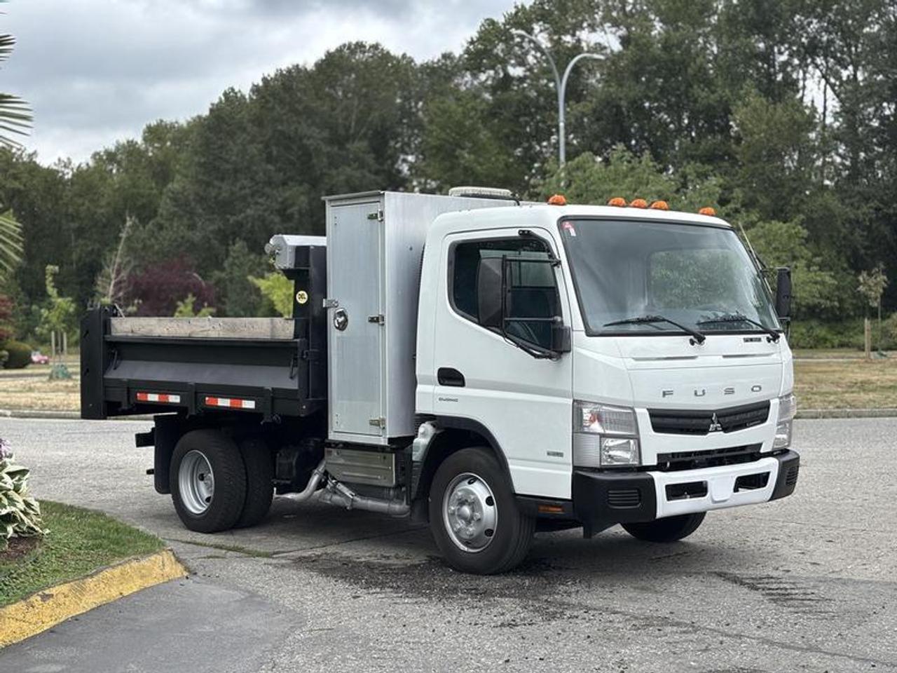 This 2015 Mitsubishi Fuso FE160 is powered by a 3.0L 4-cylinder turbo diesel engine paired with an automatic transmission and a 4x2 drivetrain. Equipped with a dump body measuring approximately 9 feet 4 inches long by 7 feet 6 inches wide, this truck is configured for construction, landscaping, municipal, and general material hauling applications.

The dump body includes exterior storage cabinets, a tarp system, and beacon lights to support a variety of worksite tasks. Inside the cab, features include heated mirrors, power windows, power door locks, cruise control, AM/FM radio, and air conditioning and heat for operator comfort.

Overall vehicle dimensions are approximately 17 feet 10 inches long, 8 feet 4 inches wide, and 8 feet high. The dump bed has side heights ranging from approximately 1 foot 4 inches to 1 foot 9 inches.

Finished in white with a blue cloth interior, this Mitsubishi Fuso FE160 offers a compact commercial dump truck platform well suited for urban job sites and fleet operations. This item is currently OFFSITE. You must register an appointment with our office to schedule an offsite viewing. Appointments must be made a minimum of one business day in advance (and as defined by the days that Repo.com is open for business) before your appointment can be scheduled and confirmed. We may, at our own discretion, instead opt to transport smaller items to Repo.coms main yard for viewing purposes.  $56,710.00 plus $375 processing fee, $57,085.00 total payment obligation before taxes.   Listing report, warranty, contract commitment cancellation fee. All above specifications and information is considered to be accurate but is not guaranteed and no opinion or advice is given as to whether this item should be purchased. We do not allow test drives due to theft, fraud, acts of vandalism and undetectable impaired driving. Instead we provide the following benefits: Complimentary Warranty (with options to extend), Limited Money Back Satisfaction Guarantee on Fully Completed Contracts, Contract Commitment Cancellation, and an Open-Ended Sell-Back Option. Ask seller for details or call 604-522-REPO(7376) to confirm listing availability.