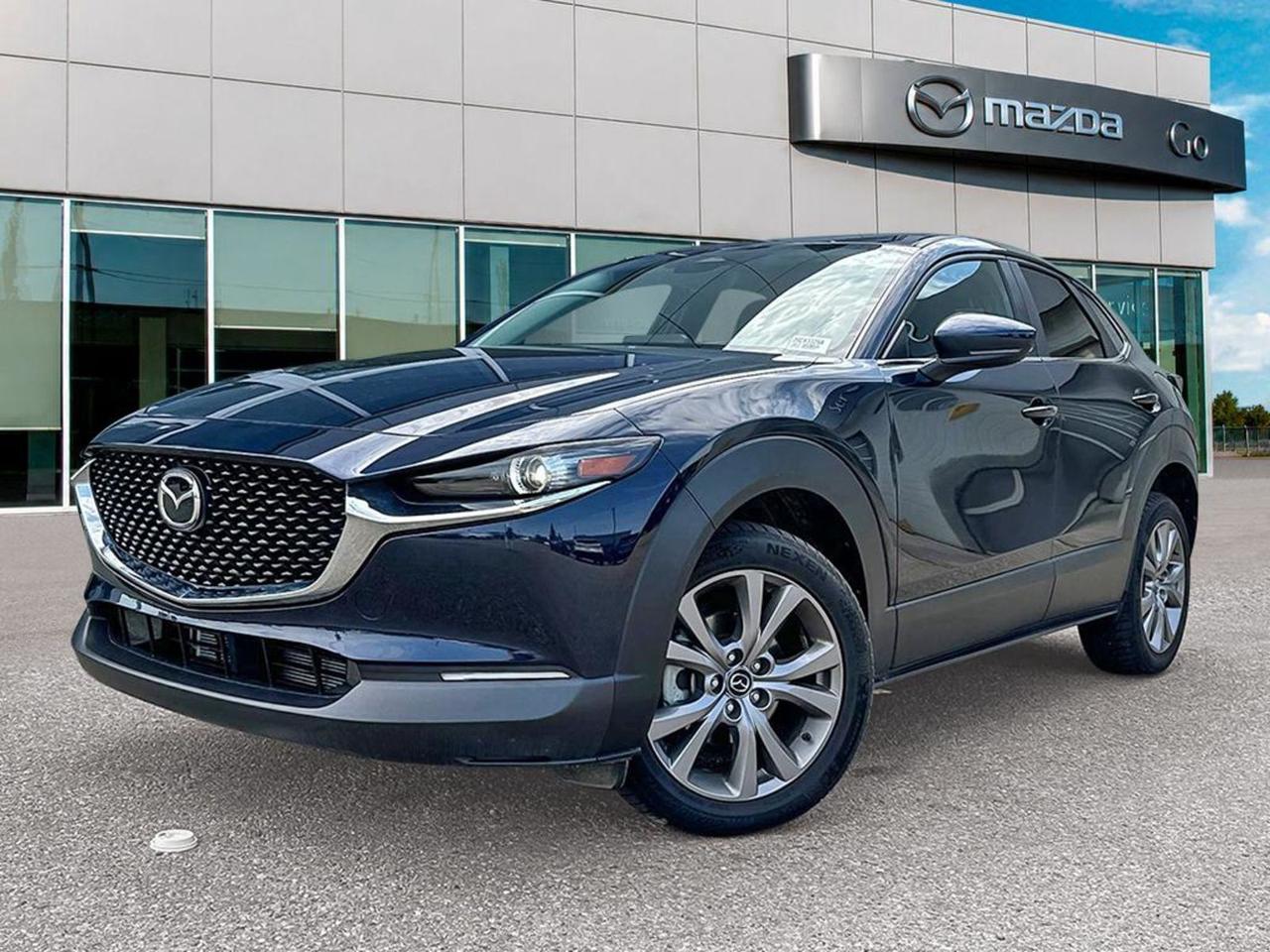 **Meet the 2024 MazdaCX30GSAWD  Bluebonnet confidence, preowned, ready to drive.** - **AllWheel Drive & 2.5L SKYACTIVG I4**  Seamless power (6speed SKYACTIVDrive) and traction wherever the road takes you. - **Comfort that warms up**  Heated front seats with three temperature settings and a leatherwrapped steering wheel, plus dualzone automatic climate control for you and rear passengers. - **Tech that stays connected**  12inch Uconnect (WiFi, Bluetooth, Android Auto/Apple CarPlay), 19speaker Harman/Kardon sound, wireless phone charging and a rearview camera with parkingassist alerts. - **Safety first**  Mazdas iActivesense suite: PedestrianEmergency Braking, LaneDeparture Prevention, BlindSpot Monitoring, Adaptive Cruise Control with StopandGo, and 10 airbagsincluding knee and curtain airbags. **Why its a smart buy:** - **Blue exterior with sleek blackgrille accents**  eyecatching style that holds its value. - **Fully equipped cargo**  liftgate, 60/40 splitfold rear seat, underfloor spare, and a sturdy, galvanized steel body with sideimpact beams for peace of mind. - **Unmatched value**  low mileage, comprehensive maintenance history, and a certified preowned warranty (36month unlimited mileage) for worryfree ownership. **Ready for your next adventure?** Swing by GoMazda today, take the CX30 for a spin, and lock in an exclusive preowned price plus financing specials. Your roadready, premiumpacked compact SUV is waiting. Go Mazda is an AMVIC licensed business.Clean CarFax