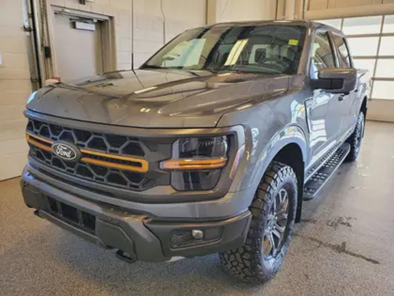 The all-new 2025 Ford F-150 Tremor 402A showcased in Carbonized Grey Metallic. This truck is equipped with the high-performance 3.5L V6 EcoBoost engine, producing 400 horsepower and 500 lb-ft of torque. With its 10-speed automatic transmission, also delivering a combined highway/city fuel economy of 12.9L/100km (22 miles per gallon). 

Key Features:
Bed Utility Package
Mobile Office Package
Tow/Haul Package
Front Axle W/Torsen Differential
Selectable Drive Modes
18 Alloy W/ Dark Matte Finish Wheels
Heated Front Seats & Rear Seats
Ford Co-Pilot 360 Assist 2.0
Adaptive Cruise Control
Lane Centering
Evasive Steering Assist
Front Parking Sensors
Pro Trailer Backup Assist
Pro Trailer Hitch Assist
14 Speaker B&O Unleashed Sound System
Hill Descent Control
Remote Start System

The 2026 F-150 Tremor 402A is built to conquer Saskatchewans toughest terrain, offering superior off-road capability, advanced technology, and premium comfort. Whether youre tackling backcountry trails or towing with confidence, this truck ensures a smooth ride with heavy-duty off-road shocks, unique Tremor control arms, and selectable drive modes, including Rock Crawl mode. 

Moose Jaw Ford, conveniently located at 1010 North Service Road in Moose Jaw, is your trusted destination for all your automotive needs. With an impressive 4.8-star Google rating from nearly 1,500 reviews, we are proud to deliver an exceptional vehicle-buying experience tailored just for you. Our Moose Jaw Motives set us apart, offering unbeatable value like half-priced oil changes for life on pre-owned vehicles, one year of key and remote protection, and one year of tire and rim protection. Enjoy peace of mind with every purchase. At Moose Jaw Ford, were committed to driving positive change in our community by combining exceptional service, high-quality vehicles, and a guest-first approach. Visit us today!