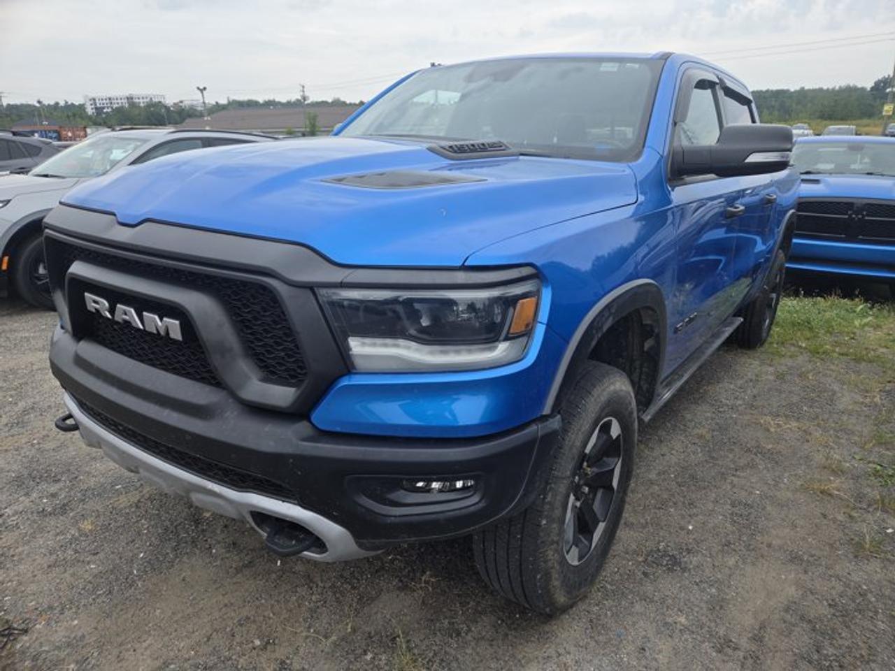 New Price!CARFAX Canada No Reported AccidentsHydro Blue Pearlcoat 2022 Ram 1500 Sport/Rebel 4WD 8-Speed Automatic HEMI 5.7L V8 VVT1-Year SiriusXM Subscription, 12 Touchscreen, 2nd Row In-Floor Storage Bins, 4-Way Front Headrests, 4-Wheel Disc Brakes, 4G LTE Wi-Fi Hot Spot, 6 Speakers, 8.4 Touchscreen, 9 Alpine Speakers w/Subwoofer, ABS brakes, Air Conditioning, Apple CarPlay Capable, Auto-dimming door mirrors, Auto-dimming Rear-View mirror, Black Dual Exhaust Tips, Block heater, Brake assist, Bucket Seats, Cloth/Vinyl Bucket Seats, Compass, Connected Travel & Traffic Services, Connectivity - US/Canada, Delay-off headlights, Disassociated Touchscreen Display, Door Trim Panel Foam Bottle Insert, Driver door bin, Dual front impact airbags, Dual front side impact airbags, Electronic Stability Control, Emergency communication system: SiriusXM Guardian, Exterior Mirrors w/Courtesy Lamps, Exterior Mirrors w/Turn Signals, For Details Visit DriveUconnect.ca, Front anti-roll bar, Front Bucket Seats, Front fog lights, Front Heated Seats, Front reading lights, Front Seatback Map Pockets, Front wheel independent suspension, Fully automatic headlights, Google Android Auto, GPS Antenna Input, GPS Navigation, Hands-Free Phone & Audio, Hands-Free Phone Communication, HD Radio, Heated door mirrors, Heated Exterior Mirrors, Heated Steering Wheel, Illuminated entry, Integrated Centre Stack Radio, Leather steering wheel, Level 1 Equipment Group, Low tire pressure warning, Occupant sensing airbag, Off-Road Info Pages, Outside temperature display, Overhead airbag, Overhead console, Panic alarm, ParkView Rear Back-Up Camera, Passenger vanity mirror, Power 2-Way Driver Lumbar Adjust, Power Adjustable Pedals, Power door mirrors, Power driver seat, Power Folding Exterior Mirrors, Power steering, Power windows, Quick Order Package 25W Rebel, Radio data system, Radio: Uconnect 3 w/5 Display, Radio: Uconnect 5 w/8.4 Display, Radio: Uconnect 5W Nav w/12.0 Display, Rear 60/40 Folding Seat, Rear anti-roll bar, Rear Dome Lamp w/On/Off Switch, Rear step bumper, Rear Wheelhouse Liners, Rear Window Defroster, Remote keyless entry, SiriusXM Satellite Radio, SiriusXM w/360L On-Demand Content, Speed control, Steering wheel mounted audio controls, Sun Visors w/Illuminated Vanity Mirrors, Tachometer, Telescoping steering wheel, Tilt steering wheel, Traction control, Trip computer, Turn signal indicator mirrors, Universal Garage Door Opener, USB Mobile Projection, Voltmeter.Certification Program Details: 80 Point Inspection Fresh Oil Change Full Vehicle Detail Full tank of Gas 2 Years Fresh MVI Brake through InspectionAt Steele GMC Buick Fredericton, were proud to be your Used Car Mega Center serving drivers all across Atlantic Canada from Fredericton, Oromocto, New Maryland, Woodstock, Saint John, and Moncton in New Brunswick, to Nova Scotia, Prince Edward Island, and Newfoundland. Our inventory features all makes and models of used cars, trucks, SUVs, and vans, giving you the best selection in the region. Whether you need a fuel-efficient sedan, a family SUV, or a rugged pickup, youll find it right here at Steele GMC Buick Fredericton. With our Market Value Pricing, every vehicle is priced based on real-time market conditions, ensuring you get the best possible deal without the hassle of negotiating. We keep pricing transparent and competitive so you can shop with total confidence. No matter your credit situation good, bad, or no credit at all youre approved. Our finance experts work with lenders across Atlantic Canada to find the best terms for your budget, including second-chance financing, newcomer programs, and credit rebuilding solutions. As part of Steele Auto Group, Atlantic Canadas most diversified automotive group with 47 dealerships representing 27 brands, we offer unmatched selection, buying power, and customer support. That means if the vehicle you want isnt on our Fredericton lot