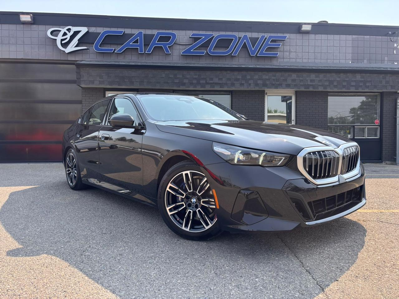 <p>Experience the pinnacle of automotive excellence with this stunning pre-owned 2026 BMW 5 Series 530i xDrive M Package, now available at Car Zone. Dressed in a sophisticated black exterior and complemented by a sleek black interior, this sedan exudes an understated yet powerful presence. Designed for the discerning driver who demands both luxury and performance, this BMW 5 Series offers an exhilarating driving experience in all Canadian conditions thanks to its intelligent all-wheel-drive system. With only 22,011 kilometers on the odometer, this vehicle represents an exceptional opportunity to own a nearly new luxury sedan.</p><p>This 2026 BMW 5 Series 530i xDrive M Package is more than just a car; its a statement. The M Package transforms an already impressive vehicle into something truly special, enhancing its dynamic capabilities and visual appeal. Whether youre navigating city streets or embarking on a longer journey, the refined interior and advanced technology ensure every drive is a pleasure. At Car Zone, we pride ourselves on offering vehicles that represent the best in quality and value, and this BMW 5 Series is no exception.</p><p>Here are five of the most captivating features that make this 2026 BMW 5 Series 530i xDrive M Package an irresistible choice:</p><ul><li><strong>M Package Performance & Style:</strong> Elevate your driving with the aggressive aerodynamic enhancements, sport-tuned suspension, and distinctive M badging that not only look incredible but also contribute to a more engaging driving experience.</li><li><strong>xDrive All-Wheel Drive:</strong> Conquer any road or weather condition with confidence. BMWs intelligent xDrive system constantly optimizes power distribution for superior traction, stability, and dynamic handling.</li><li><strong>Luxurious Black Leather Interior:</strong> Immerse yourself in unparalleled comfort and sophistication within the meticulously crafted black leather cabin, designed for both driver and passengers.</li><li><strong>Powerful and Efficient 530i Engine:</strong> Experience seamless acceleration and responsive power, all while maintaining impressive fuel efficiency, making every drive both thrilling and practical.</li><li><strong>Cutting-Edge BMW Technology:</strong> Benefit from the latest in-car entertainment, connectivity, and driver-assistance systems that ensure youre always informed, entertained, and safe on the road.</li></ul><p><strong><em>Powered by AutoIntelligence&trade;</em></strong></p><p>Vehicle information has been generated using artificial intelligence and is provided for informational purposes only. While efforts are made to ensure accuracy, please confirm all details directly with the dealer.</p>