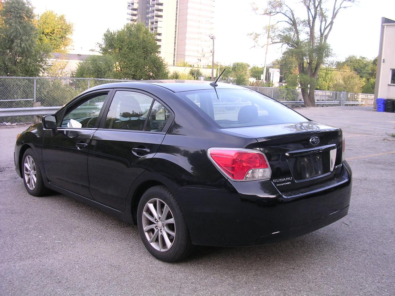 2012 Subaru Impreza 4dr Sdn CVT 2.0i w/Touring Pkg Photo