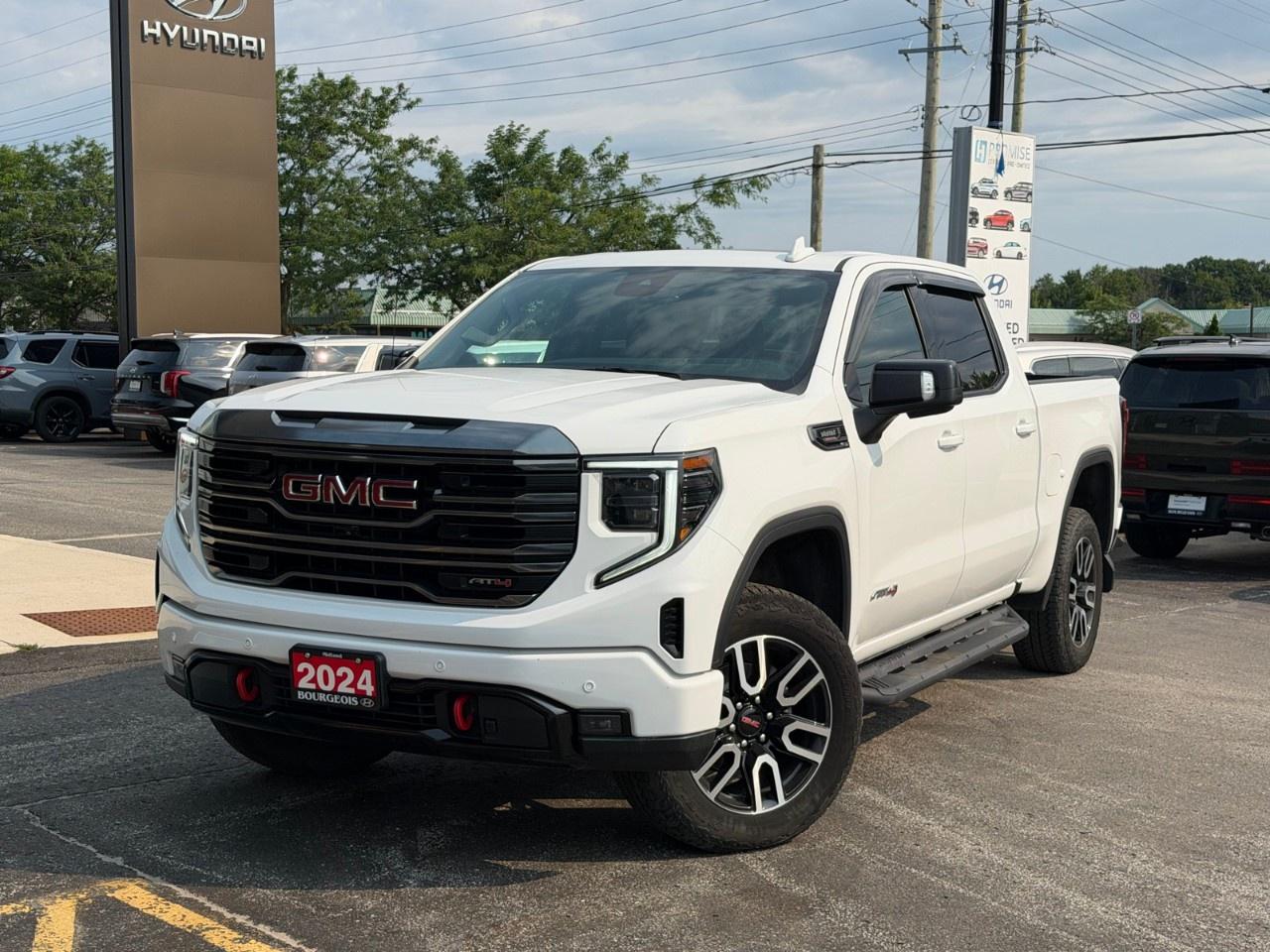<p>Introducing the 2024 GMC Sierra 1500 AT4! This white powerhouse boasts a 4×4 drivetrain, ensuring exceptional handling and a commanding presence on any road.</p> <p>The exterior is a testament to rugged sophistication, featuring a strong design fit for both work and pleasure, while the black interior offers a stylish, comfortable drive. Equipped with leather seats, this truck provides heated and cooled front seats, demonstrating a commitment to sophisticated comfort.</p> <p>Technologically, the Sierra 1500 AT4 is a marvel, equipped with a cutting-edge navigation system, a backup camera for easy maneuvering, and a smart device integration feature to keep you connected. Safety is paramount, and this vehicle includes lane assist, parking sensors, and a wi-fi hotspot to ensure your journeys are both secure and convenient.</p> <p>This truck is perfect for those who require both powerful performance and advanced features, making it an ideal choice for adventurers and professionals alike. Contact Bourgeois Midland Hyundai today for more details on how you can make this remarkable truck your own.</p> <p><strong>Why Choose the Bourgeois Auto Group?</strong></p><p>For 80 years, Bourgeois Auto Group has been delivering exceptional automotive experiences. Our factor trained teams work to ensure you receive the shopping experience you deserve; whether you're looking for a new or new-to-you vehicle.</p><p>Shop 24/7 with our online showroom and chat service, ensuring convenience every step of the way. No hidden fees, full disclosure, and every pre-owned vehicle comes with a Carfax® report for peace of mind.</p><p>We offer a wide selection of pre-owned vehicles, all competitively priced using real-time market data. Get the best deal on your purchase and trade-in with our free Live Market Analysis report.</p><p>Looking to sell your car? We buy any make or modelno purchase required. Our simple to use online trade valuation tool will provide you with a clear, transparent selling experience whether you buy our car or not.</p><p>Backed by hundreds dedicated employees across 4 convenient locations, were here to meet all your automotive needs. Visit us in Midland or Parry Sound and explore our inventory or schedule your next service today.</p> <p><strong>Financing Your Next Vehicle with Bourgeois Midland Hyundai:</strong></p><p>At Bourgeois Midland Hyundai, we make financing your next vehicle simple and stress-free! Our team works with trusted lenders to find flexible options tailored to your budget. Drive away with confidenceapply today!</p><p>Take advantage of our online pre-qualification tool, backed by Equifax and TD Bank to find the payment that works for you. Simply <a href=https://www.bourgeoishyundai.com/pre-qualify-for-financing/ rel=nofollow><strong>CLICK HERE</strong></a> to use our secure online credit tool with no impact to your credit. </p>