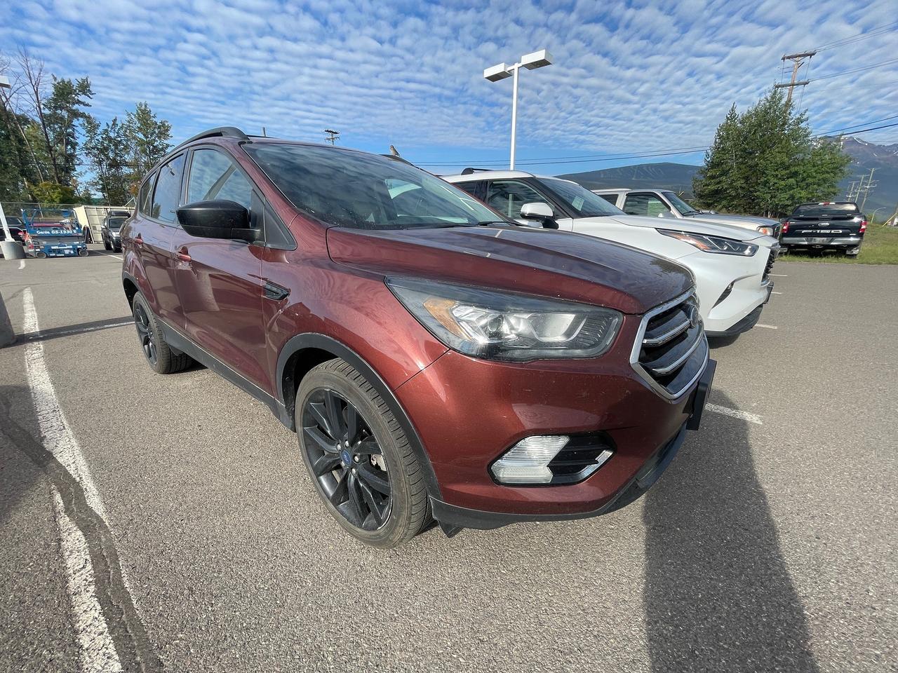 <p>Looking for a versatile and capable SUV thats ready for anything Canadian roads can throw at it? Smithers Toyota has the perfect pre-owned vehicle for you: a 2018 Ford Escape SE. This stylish SUV is equipped with a robust 4-wheel drive system, making it ideal for navigating snowy highways, gravel roads, or simply providing extra confidence in any weather. With only 192,487 kilometers on the odometer, this Escape SE has plenty of adventures left to offer. Its comfortable interior and practical features make it a fantastic choice for daily commutes, weekend getaways, and everything in between.</p><p>&nbsp;</p><p>The 2018 Ford Escape SE boasts a fuel-efficient 1.5L EcoBoost engine with auto-start-stop technology, designed to help you save at the pump without sacrificing performance. Inside, youll find a well-appointed cabin with dual-zone automatic climate control to keep everyone comfortable, and a user-friendly infotainment system with Bluetooth connectivity for seamless music streaming and hands-free calls. The spacious cargo area, complete with liftgate access and cargo space lights, ensures you can easily pack for any trip. Plus, with a suite of advanced safety features, you can drive with peace of mind.</p><p>&nbsp;</p><p>Here are 5 features that make this 2018 Ford Escape SE a standout:</p><p><br><br></p><ul><li><strong>Automatic Full-Time Four-Wheel Drive:</strong> Conquer any terrain or weather condition with confidence, from icy roads to muddy trails.</li></ul><p>&nbsp;</p><ul><li><strong>1.5L EcoBoost Engine with Auto-Start-Stop Technology:</strong> Experience a smart blend of power and fuel efficiency, saving you money on gas.</li></ul><p>&nbsp;</p><ul><li><strong>Dual Zone Front Automatic Air Conditioning:</strong> Keep both the driver and front passenger perfectly comfortable with individual temperature controls.</li></ul><p>&nbsp;</p><ul><li><strong>Back-Up Camera:</strong> Maneuver into tight parking spots with ease and enhanced visibility.</li></ul><p>&nbsp;</p><ul><li><strong>Bluetooth Wireless Phone Connectivity:</strong> Stay connected on the go with hands-free calling and audio streaming.</li></ul><p><br><br></p><p><strong><em>Powered by AutoIntelligence&trade;</em></strong></p><p>&nbsp;</p><p>Vehicle information has been generated using artificial intelligence and is provided for informational purposes only. While efforts are made to ensure accuracy, please confirm all details directly with the dealer.</p><p>&nbsp;</p>