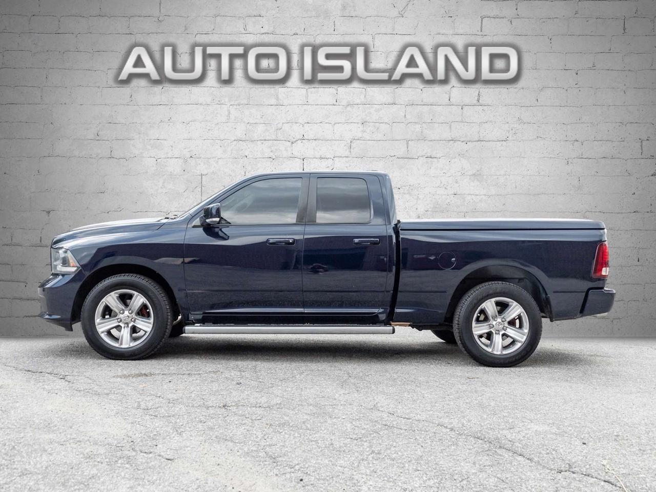 2015 RAM 1500 4WD Quad Cab 140.5 Sport Photo