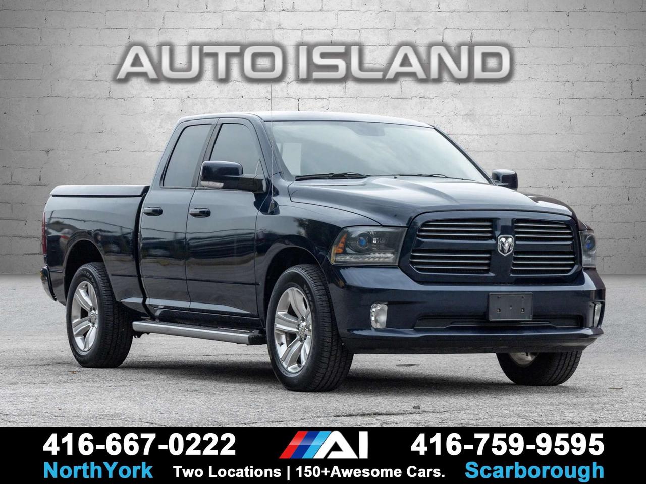 2015 RAM 1500 4WD Quad Cab 140.5 Sport Photo0