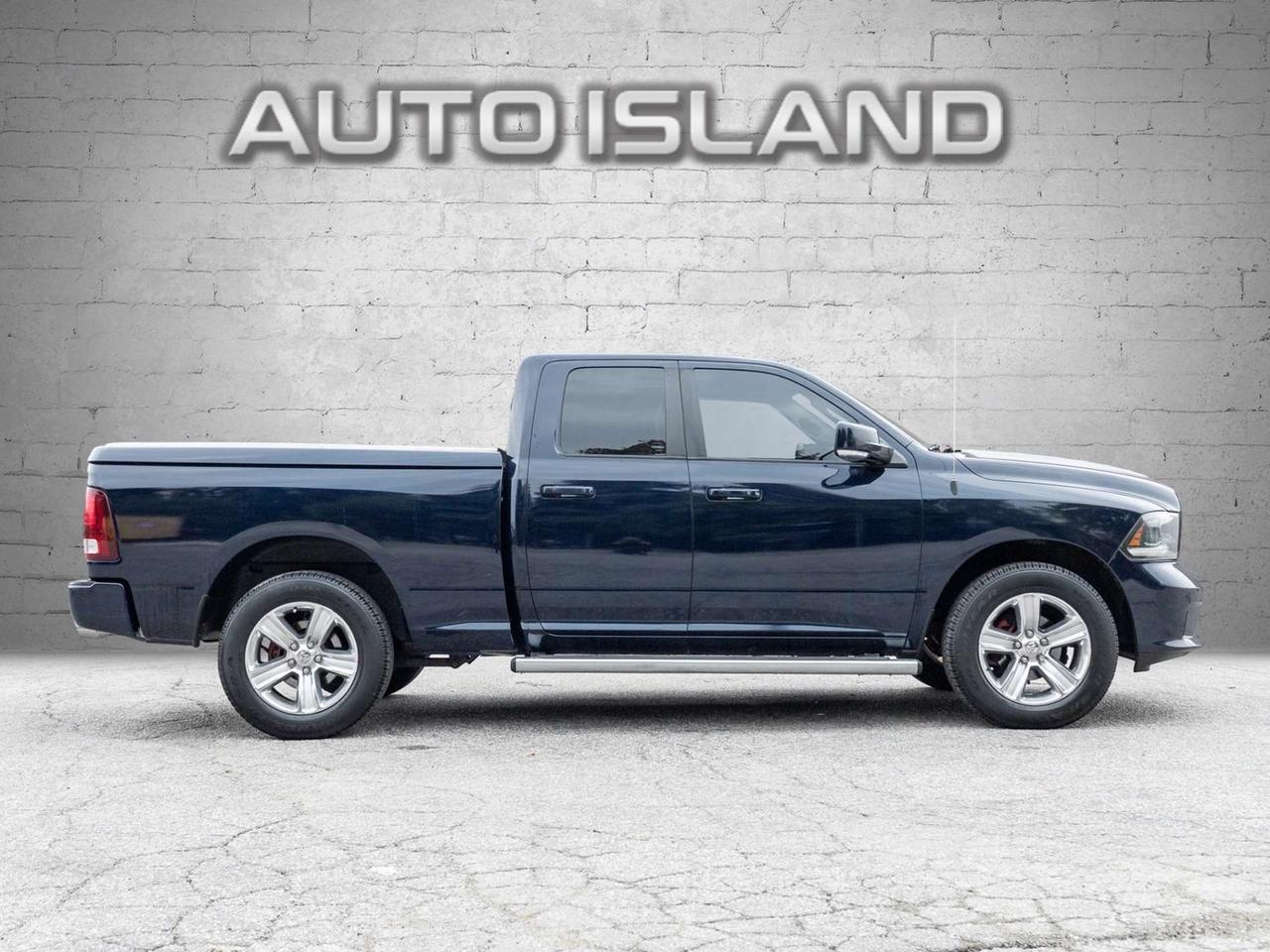 2015 RAM 1500 4WD Quad Cab 140.5 Sport Photo
