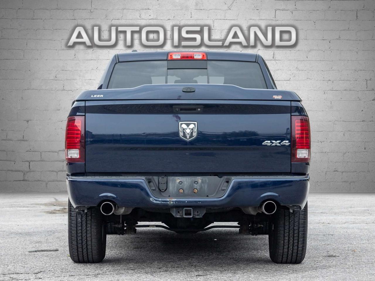2015 RAM 1500 4WD Quad Cab 140.5 Sport Photo