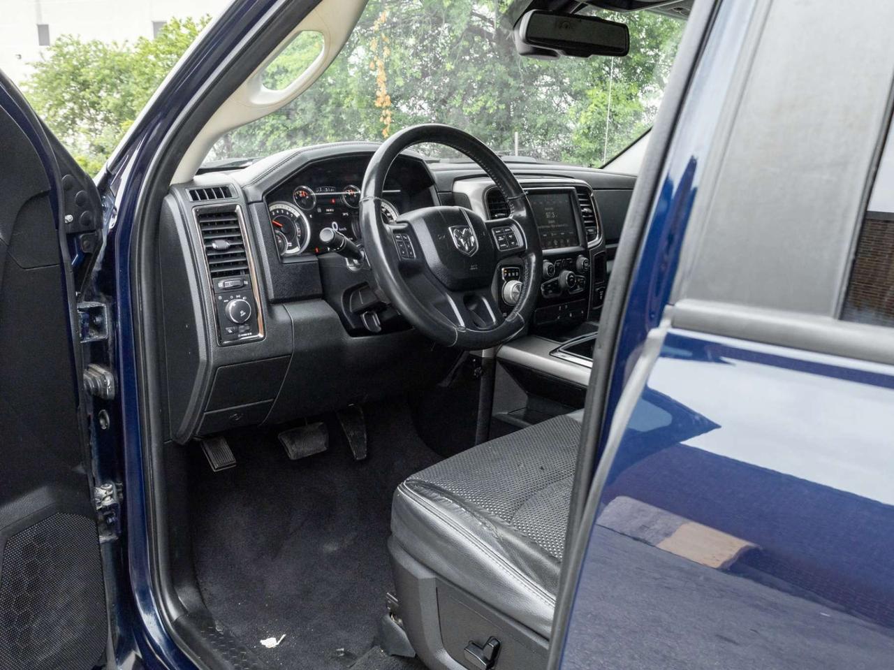2015 RAM 1500 4WD Quad Cab 140.5 Sport Photo