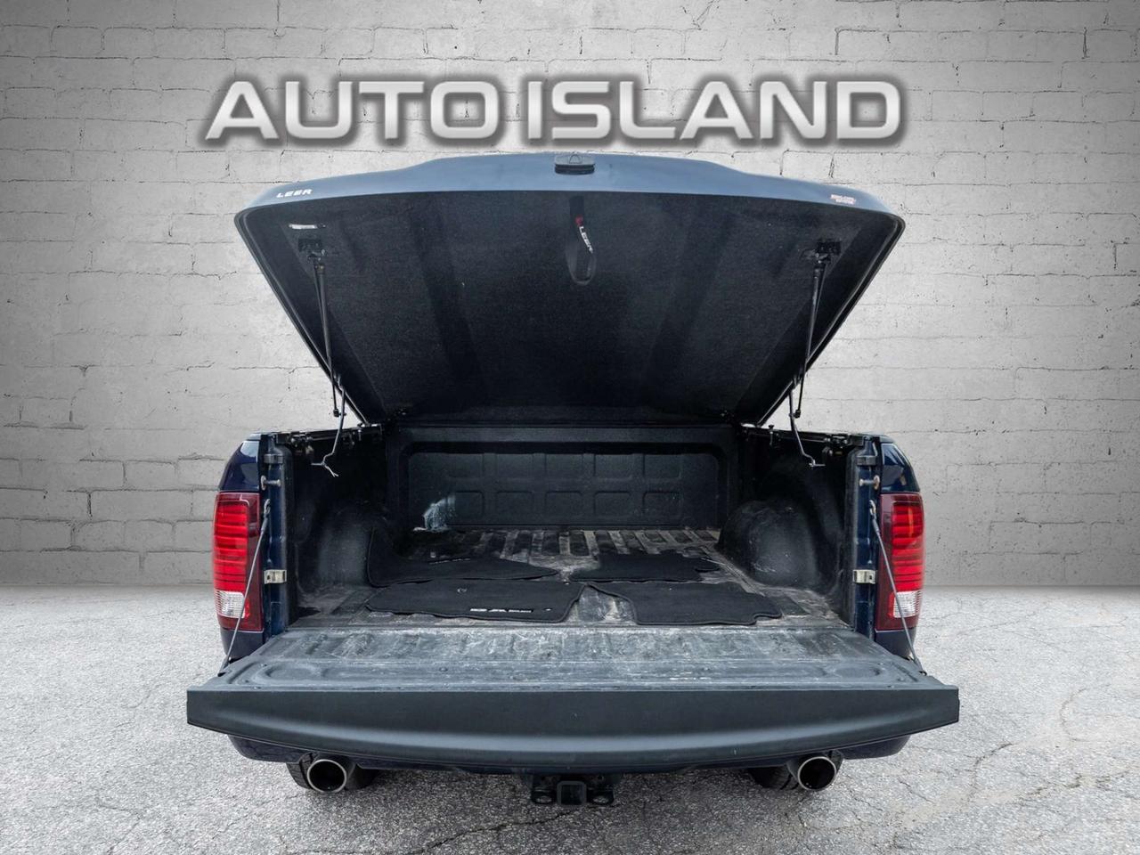 2015 RAM 1500 4WD Quad Cab 140.5 Sport Photo