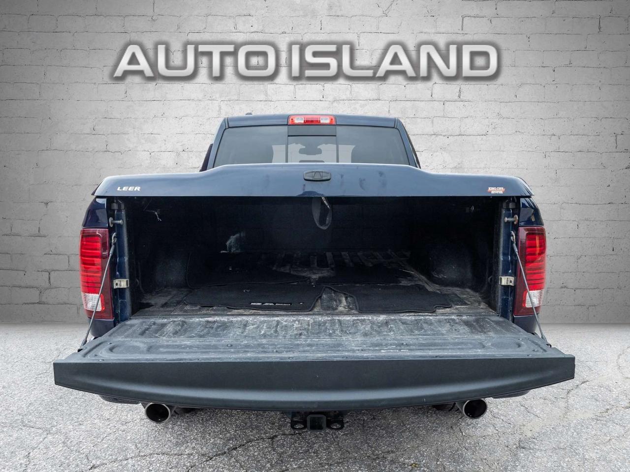 2015 RAM 1500 4WD Quad Cab 140.5 Sport Photo