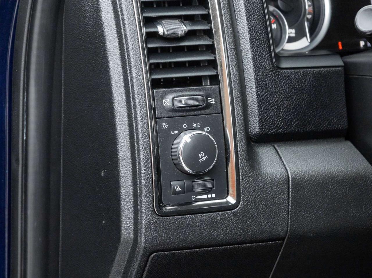 2015 RAM 1500 4WD Quad Cab 140.5 Sport Photo