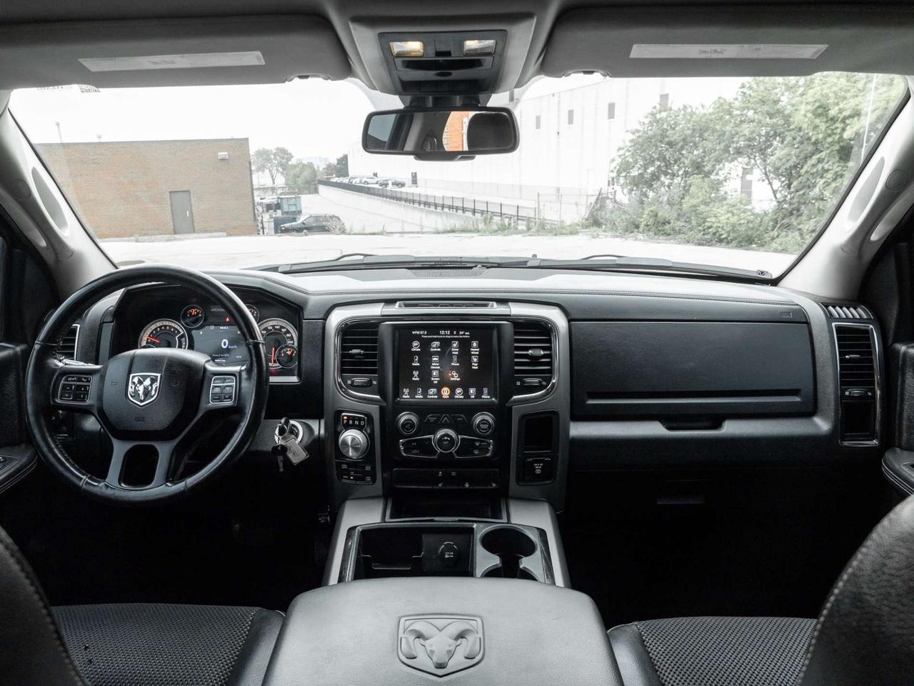 2015 RAM 1500 4WD Quad Cab 140.5 Sport Photo