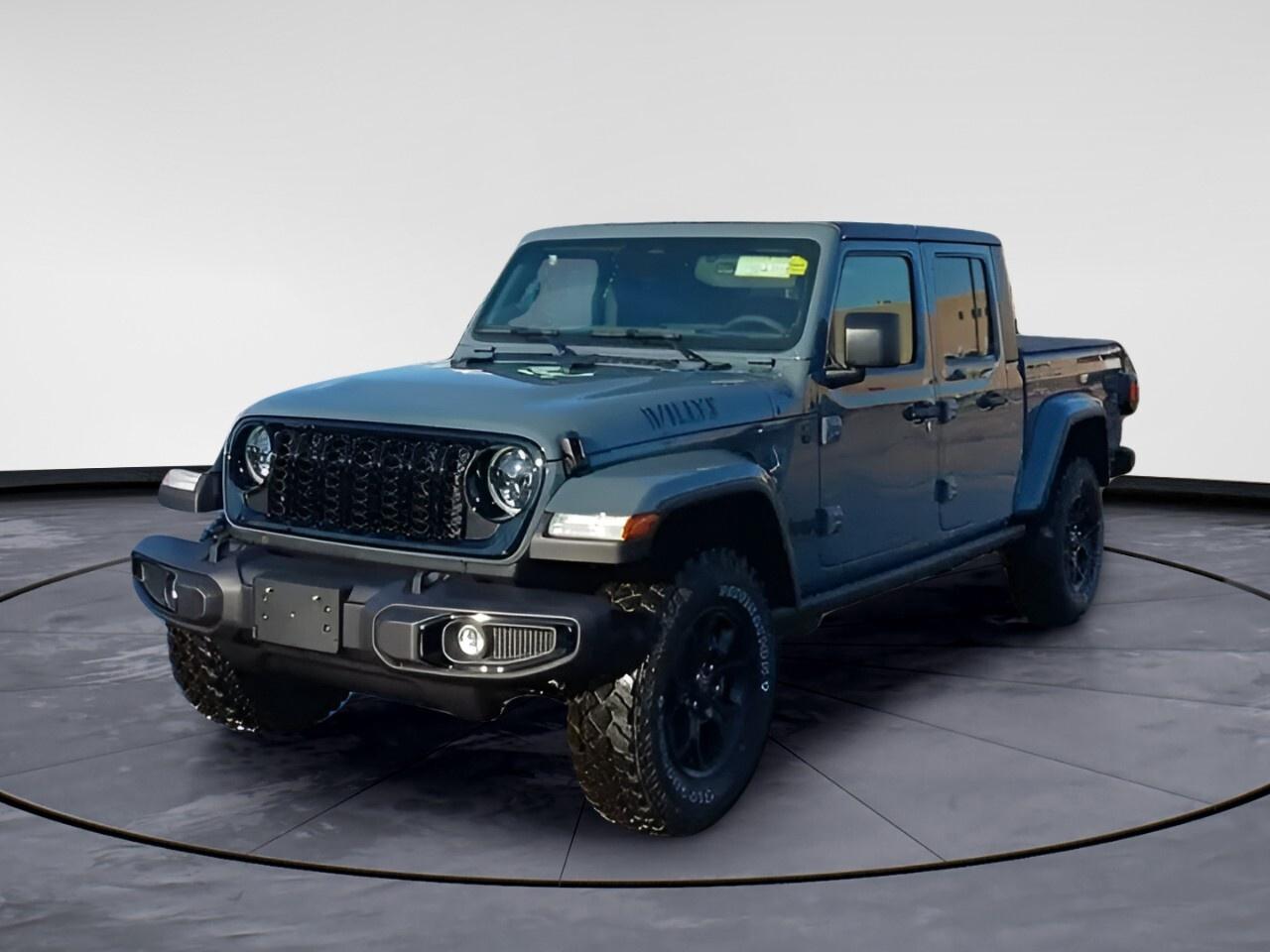 Experience adventure behind the wheel of the stunning gray 2026 Jeep Gladiator Willys 4x4. Renowned for its exceptional handling and versatility, this truck is ready for the challenges of both city streets and rugged off-road trails with its robust 4x4 drivetrain and advanced off-road features.

Outside, the Gladiator boasts a commanding presence with a Gloss Black Bumper, Black Grille, and Willys Hood Decal, accentuated by the LED Reflector Headlamps and Fog Lamps that ensure you stay visible in all conditions. The Protection Sill Rails and Heavy-Duty Red Shock Absorbers are designed to tackle tough terrains, while the Class IV Hitch Receiver with Trailer Hitch Zoom is perfect for towing your weekend toys.

Inside, comfort meets practicality with air conditioning, power windows, and a Leatherette Steering Wheel that adds a touch of luxury to your drive. Modern technology also plays a significant role, with a 7" In-Cluster Colour Display for easy monitoring, along with satellite radio and a Wi-Fi hotspot keeping you connected on the go. Cruise in comfort with Adaptive Cruise Control and the convenience of keyless entry.

Featuring a 3.6L Pentastar VVT V6 engine paired with an 8-speed automatic transmission, this Gladiator is engineered for power and efficiency. Safety is a priority with Brake Assist and Electronic Locker Rear Axle adding to your peace of mind on any journey.

Ideal for adventurers and off-road enthusiasts, the 2026 Jeep Gladiator Willys 4x4 at Windsor Chrysler is your gateway to unmatched thrills. Contact us today to learn more and start your journey towards owning this remarkable vehicle.