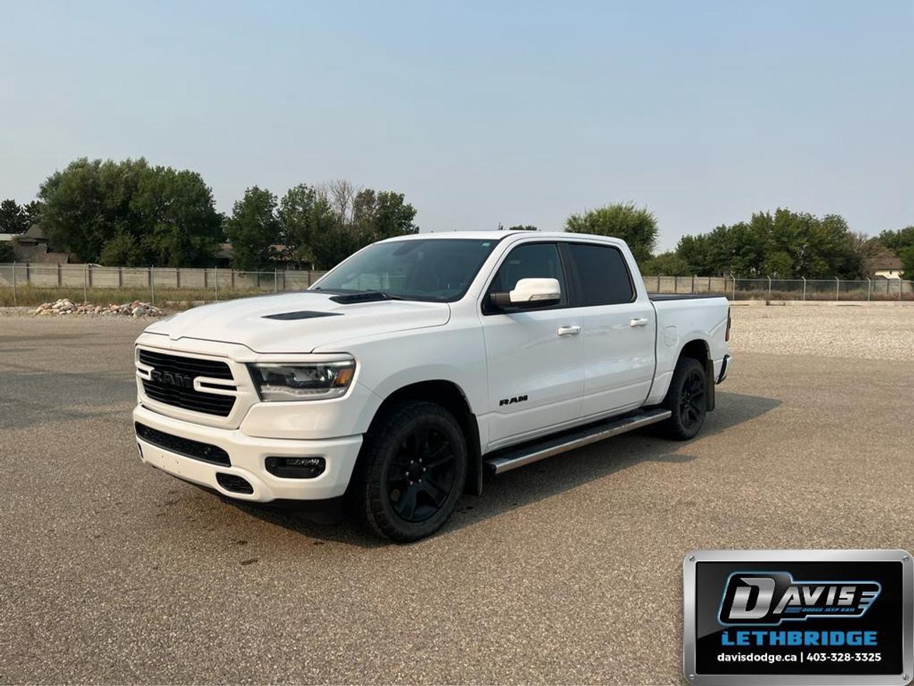 <p>The <strong>2020 Ram 1500 Sport 4x4 Crew Cab 5'7" Box</strong> in striking white with a capable 4×4 drivetrain and automatic transmission is ready to tackle any landscape with confidence. This truck offers not just power and performance, but also an outstanding driving experience.</p><p><strong>Interior Features:</strong></p><ul><li>Heated front seats for ultimate comfort</li><li>Commanding heated leather steering wheel</li><li>Convenient smart device integration enhancing connectivity</li><li>Easy-to-use cruise control for those long drives</li></ul><p><strong>Exterior Features:</strong></p><ul><li>Sleek alloy wheels adding a touch of sophistication</li><li>White exterior that commands attention</li><li>Effortless keyless entry for ease of access</li><li>Power windows for added convenience</li></ul><p><strong>Technology & Safety Features:</strong></p><ul><li>Reliable backup camera for improved visibility</li><li>State-of-the-art brake assist providing enhanced safety</li><li>Bluetooth connection to seamlessly integrate your devices</li><li>Satellite radio keeping you entertained on the road</li></ul><p>This vehicle is particularly appealing to those who demand performance without compromising on comfort. Whether you're an adventurer seeking reliable transport or someone looking for a dependable daily driver, the 2020 Ram 1500 Sport is designed to meet your needs. Contact <strong>Davis Dodge Lethbridge</strong> today to learn more and arrange a test drive of this impressive truck!</p>