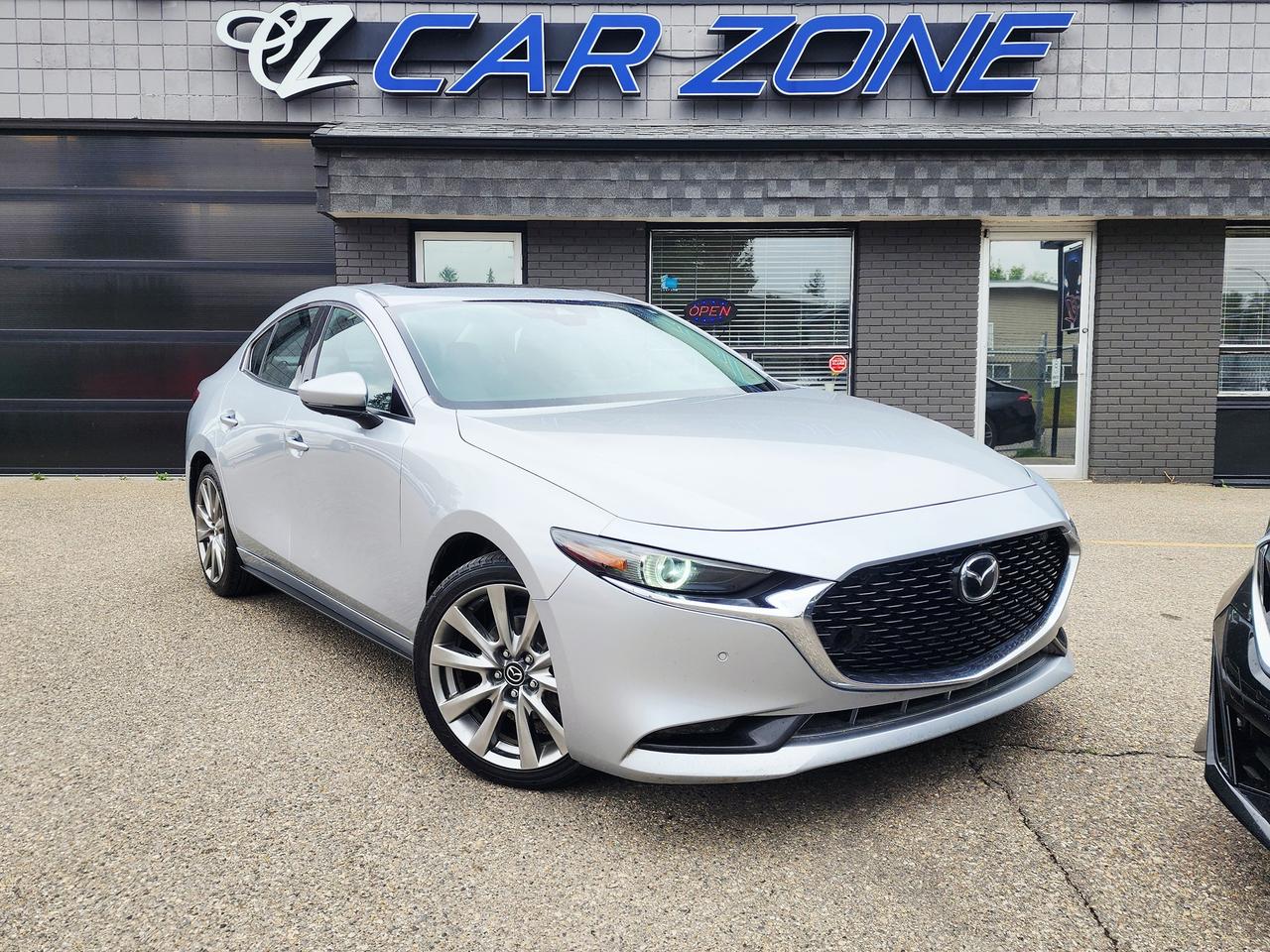 <p>Step into sophistication and style with this stunning silver 2021 Mazda MAZDA3 GT, a sedan that truly elevates your driving experience. The sleek exterior catches the eye, while the luxurious black leather interior cocoons you in comfort and refinement. Whether youre navigating city streets or embarking on a longer journey, this Mazda3 is designed to impress with its blend of premium features and engaging performance. Driven with care and boasting 161,698 kilometers, this vehicle offers a fantastic opportunity to own a well-appointed Mazda at Car Zone.</p><p>Experience the joy of driving every time you get behind the wheel. This MAZDA3 GT is equipped with a responsive 2.5L I4 engine paired with a smooth automatic transmission, delivering a driving dynamic thats both spirited and efficient. The sedan body style offers a perfect balance of sporty aesthetics and practical usability, making it an ideal choice for a variety of lifestyles. At Car Zone, we pride ourselves on offering quality pre-owned vehicles, and this 2021 Mazda MAZDA3 GT is no exception, ready to become your next trusted companion on the road.</p><p>Here are 5 features that make this 2021 Mazda MAZDA3 GT truly stand out:</p><ul><li><strong>Heads-Up Display:</strong> Keep your eyes on the road and all your essential information directly in your line of sight with the advanced heads-up display.</li><li><strong>Luxurious Leather Interior:</strong> Indulge in the premium feel and sophisticated look of the supple black leather seating.</li><li><strong>Powerful 2.5L I4 Engine:</strong> Enjoy a responsive and engaging driving experience with the robust performance of the 2.5-litre engine.</li><li><strong>Sleek Silver Exterior:</strong> Turn heads with the elegant and timeless silver finish that highlights the MAZDA3s sculpted design.</li><li><strong>Smooth Automatic Transmission:</strong> Effortlessly navigate any driving situation with the seamless and convenient automatic transmission</li><li>&nbsp;</li></ul><p>Vehicle information has been generated using artificial intelligence and is provided for informational purposes only. While efforts are made to ensure accuracy, please confirm all details directly with the dealer.</p><p>Looking for Your Dream Car? Call Car Zone Today!</p><p>Thanks for viewing our Car Zone inventory. All of our vehicles come fully detailed with a Carfax and a mechanical fitness assessment. Drive this home today! Easy financing options. All credit welcome.&nbsp;<strong><a href=http://www.carzonecalgary.ca/finance>APPLY NOW</a>&nbsp;</strong>We even take trades. Same day approvals at&nbsp;<a href=http://www.carzonecalgary.ca/><strong>CARZONECALGARY</strong></a> or visit us in person at 2036 36 Street SE Calgary for a hassle free test drive. Let our friendly team of experts book an appointment with you and show you the Car Zone difference! AMVIC licensed dealer.&nbsp;</p>