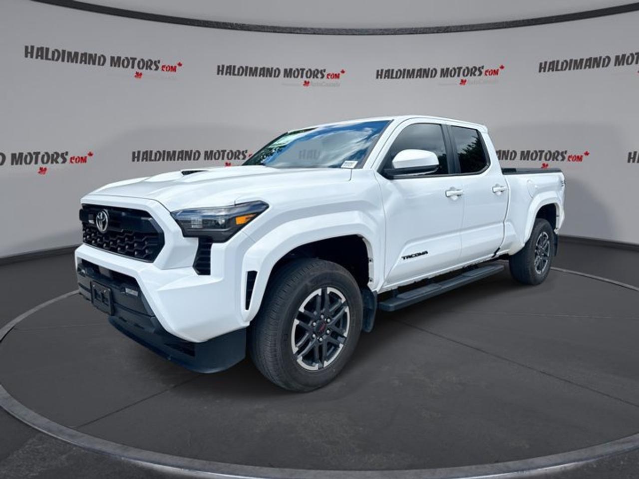 // ACCIDENT FREE!! //<br /><br />Built for work, travel, and weekend fun, this 2025 Toyota Tacoma SB Double Cab 4x4 | No Accidents is a smart midsize truck with proven Toyota strength. It comes finished in White with a Black interior, four doors, and just 23,000 km on the odometer.<br /><br />Power comes from a 2.4-litre gas engine paired with an 8-speed automatic transmission. This used Tacoma delivers smooth response, confident 4WD traction, and the everyday ease many drivers want in Cayuga. It also offers a strong 2,859 kg towing capacity for trailers, gear, or recreation.<br /><br />FEATURES OF THE Tacoma SB Double Cab 4x4 | No Accidents<br /><br />   2.4-litre gas engine with automatic transmission<br />   Four-wheel drive for added year-round traction<br />   Double Cab with four full doors<br />   White exterior with Black interior<br /><br />TRUCK FEATURES<br /><br />   Tows up to 2,859 kg confidently<br />   Trailer hitch ready for towing tasks<br />   Rear tow hook adds utility<br />   Off-road tires support rougher terrain<br /><br />ADVANCED SAFETY FEATURES<br /><br />   Backup camera helps with reversing confidence<br />   Lane departure warning adds driving support<br />   Blind spot monitor boosts lane awareness<br />   Side and head airbags enhance protection<br /><br />PERFORMANCE AND EFFICIENCY<br /><br />   2.4-litre gas engine delivers solid torque<br />   8-speed automatic supports smooth shifting<br />   Four-wheel drive improves grip year-round<br />   Limited slip differential helps traction<br /><br />COMFORT AND CONVENIENCE<br /><br />   Heated front seats add cold-weather comfort<br />   Dual-zone climate control keeps balance<br />   Push button start adds daily ease<br />   Power windows simplify every drive<br /><br />TECHNONOLGY AND CONNECTIVITY<br /><br />   Apple CarPlay keeps apps within reach<br />   Android Auto supports easy phone access<br />   Bluetooth integration supports hands-free communication<br />   Navigation system helps guide every trip<br /><br />CARGO SPACE<br /><br />   Short box handles daily hauling needs<br />   Rear trunk access adds practical loading<br />   Four-door cab supports passenger flexibility<br />   Spare tire adds travel reassurance<br /><br />WHAT OTHER OWNERS LIKE<br /><br />   Strong towing ability for midsize truck<br />   Comfortable ride for daily driving<br />   Useful technology that feels easy<br />   Confident four-wheel drive capability<br /><br />This 2025 Toyota Tacoma SB Double Cab 4x4 | No Accidents stands out with the features drivers ask for most. Heated mirrors, power steering, electric mirrors, tinted windows, steps, fog lights, LED headlamps, and automatic headlights all add practical value to your daily drive.<br /><br />Inside, this 2025 Toyota Tacoma SB Double Cab 4x4 | No Accidents is set up to make life easier. You get front air conditioning, automatic climate control, an adjustable steering wheel, steering wheel audio controls, a leather steering wheel, lumbar support for the driver, and an auto-dimming rearview mirror.<br /><br />Technology is another strong point in this 2025 Toyota Tacoma SB Double Cab 4x4 | No Accidents. Satellite radio, HD Radio, Apple CarPlay, Android Auto, Bluetooth integration, and GPS navigation help keep every trip connected, informed, and enjoyable whether you are commuting, heading to the jobsite, or planning a road trip.<br /><br />This 2025 Toyota Tacoma SB Double Cab 4x4 | No Accidents also brings helpful driver assistance features. Adaptive cruise control, tire pressure monitoring, a backup camera, automatic door locks, turn signal mirrors, and passenger airbag sensing all support safer, more relaxed driving in changing road and weather conditions.<br /><br />With its accident-free history, low 23,000 km reading, capable 4WD system, and useful mix of comfort and utility, this 2025 Toyota Tacoma SB Double Cab 4x4 | No Accidents is ready for many roles. It is a dependable Toyota truck that fits workdays, family use, towing duty, and outdoor plans with ease.<br /><br />This 2025 Toyota Tacoma SB Double Cab 4x4 | No Accidents VIN is: 3TYLB5JN4ST076856.<br /><br />WHY CHOOSE US? <br /><br />Honest & Transparent Buying Experience: Weve been a trusted name in business since 1984.<br /><br />STRAIGHTFORWARD PRICING:<br />Our Advertised Price Includes:<br />>>Safety Certification (No separate fee!)<br />>>30-Day 100% Mechanical Warranty<br />>>FREE Carfax History Report.<br />>>No upcharge for paying cash.<br />(Prices Exclude HST and Licensing Fees only.)<br /><br />>>Browse 300+ vehicles all in ONE LOCATION<br /><br />EASY FINANCING: Great rates & open loans<br /><br />WE BUY CARS: Get Top Dollar for your trade-in, or sell us your vehicle for CASH! Even if you dont buy from us!<br /><br />STOP BY TODAY<br />Treat yourself - stop by Haldimand Motors Ltd. located at 42 Talbot St E, Cayuga, ON N0A 1E0 to make this car yours today!<br /><br />https://www.haldimandmotors.com/used/stock-461047html